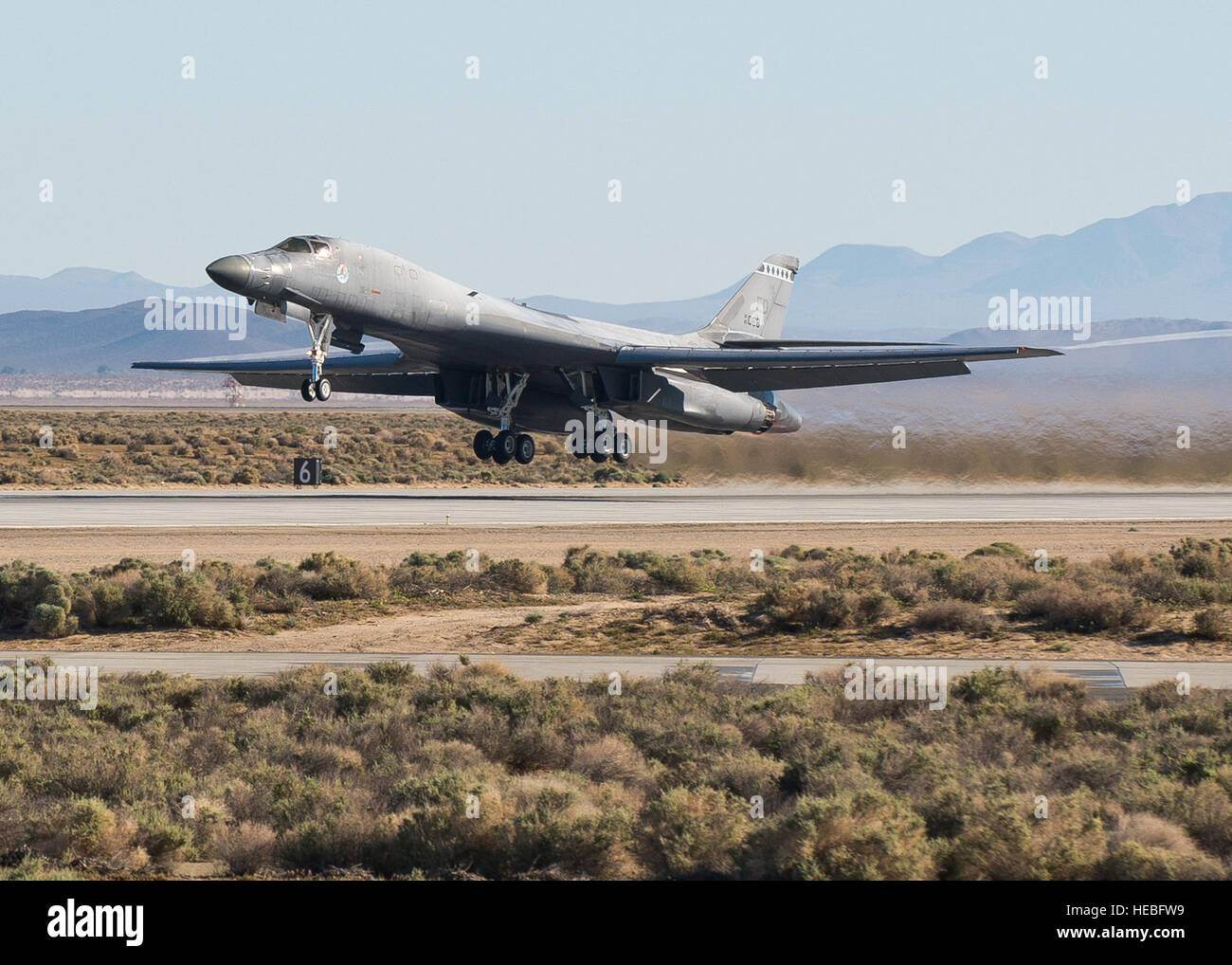 An Edwards B-1B Lancer takes off Runway 22L on April 1 to begin testing its new Sustainment Block 16A (SB 16A) software upgrades. The SB 16A software will work in conjunction with the long-range bomber’s new glass cockpit configuration in order to ensure its capabilities in a fast-paced integrated battlefield of the future. (U.S. Air Force photo by Ethan Wagner) Stock Photo