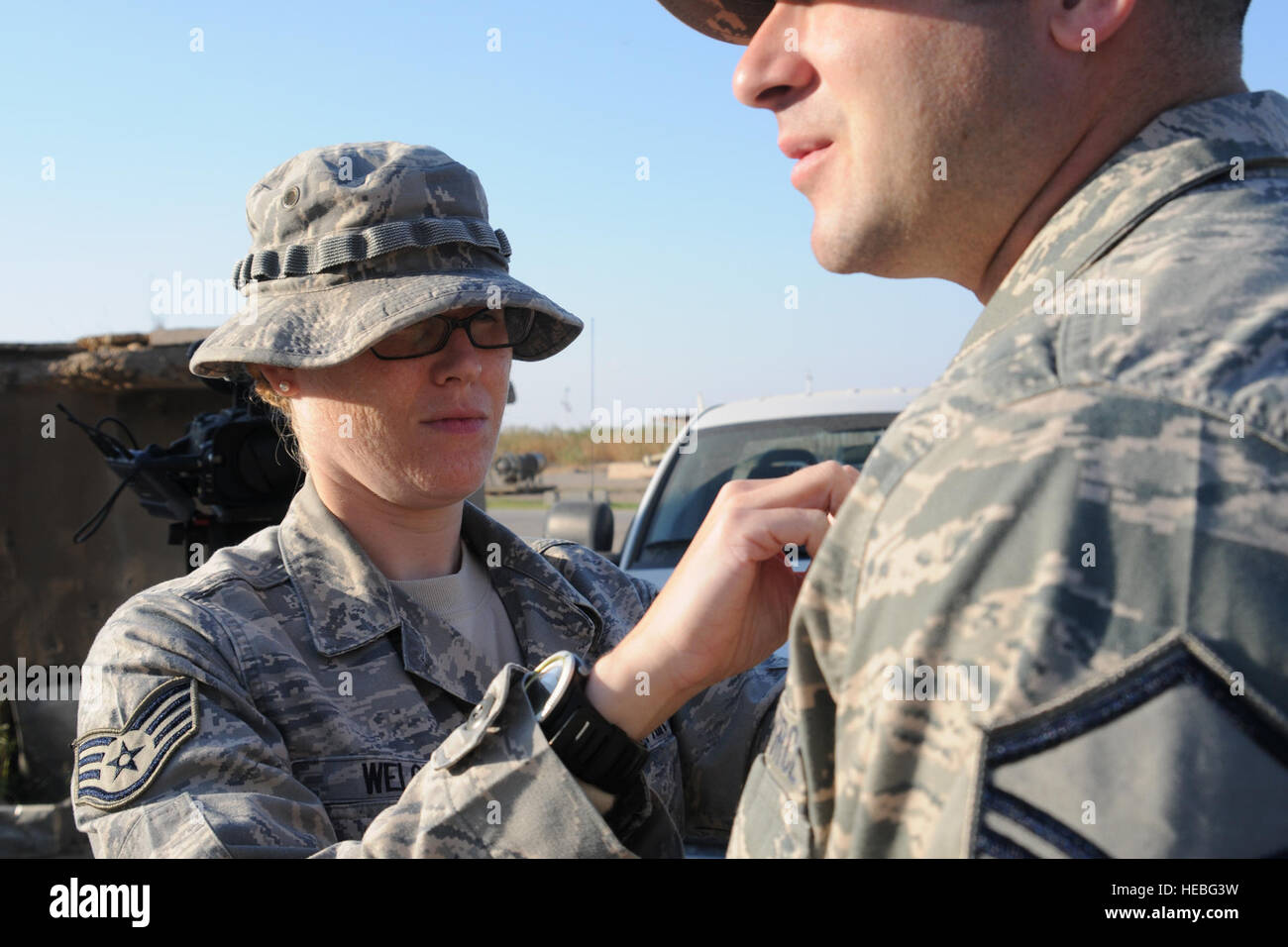 Staff Sgt. Felicia Welch, 506th Air Expeditionary Group Public Affairs broadcaster, attaches a microphone to an interviewee Nov. 23. Welch was recently recognized as the 506th Air Expeditionary Group's Warrior of the Week. A native of Sarasota, Fla., Sergeant Welch is deployed from the 48th Fighter Wing Public Affairs, Royal Air Force Lakenheath, United Kingdom. Stock Photo
