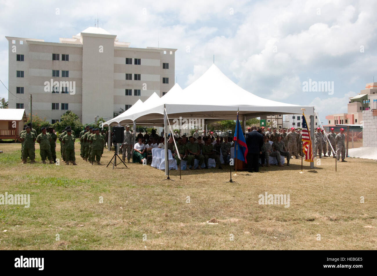 Belizean and U.S. service members stand in formation while representatives of various military services, governmental and nongovernmental organizations, and schools listen to remarks April 10, 2014, during the opening ceremony for New Horizons 2014 at Edward P. Yorke High School in Belize City, Belize. New Horizons is a U.S. Southern Command-sponsored annual series of joint humanitarian assistance exercises deploying U.S. military engineers, veterinarians, medics and other professions to Central and South American nations for training, construction projects and to provide humanitarian and medi Stock Photo