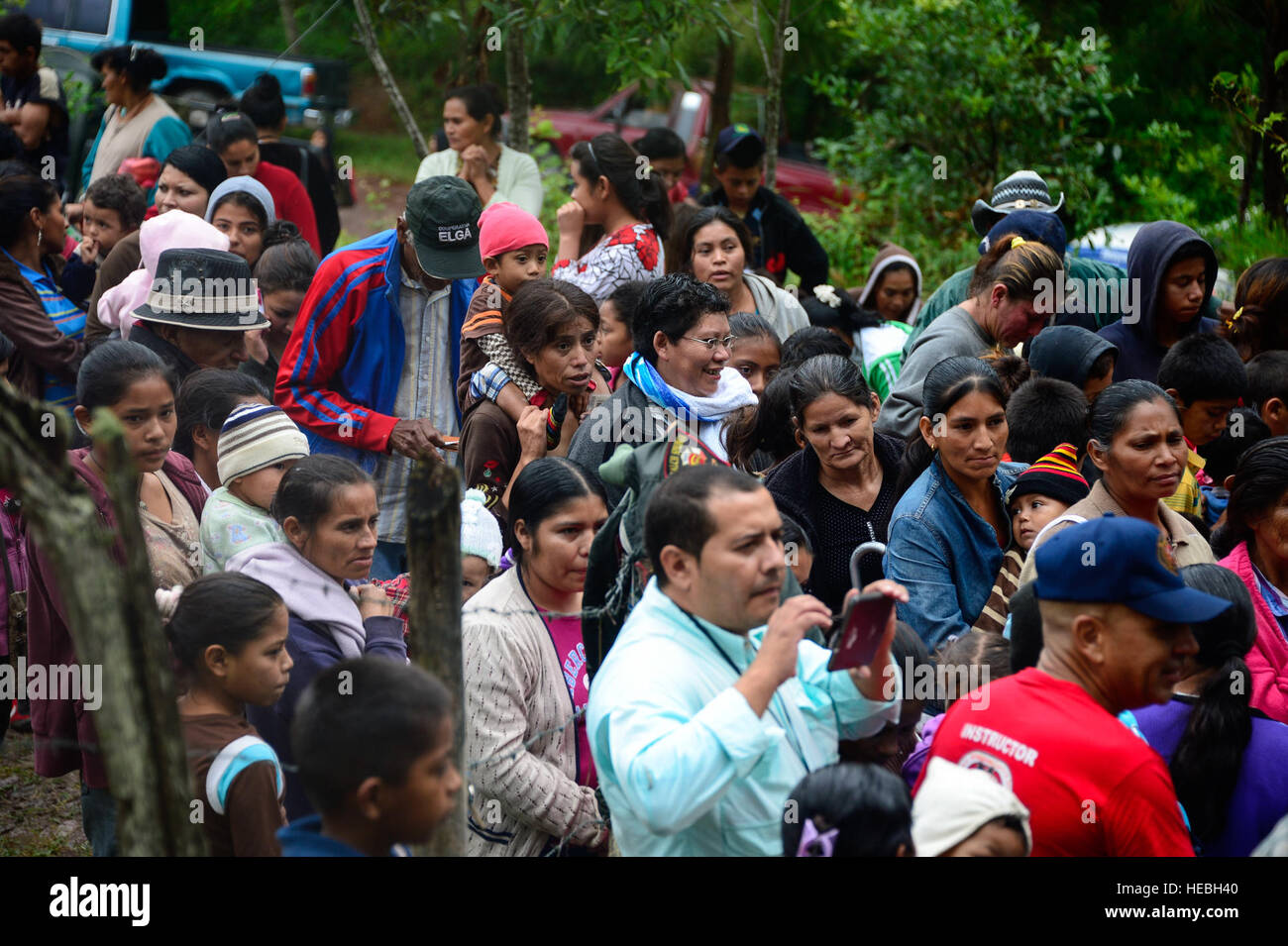 Villagers from Potrerillos, Siguatepeque, Honduras, line up to receive bags of food from members of Joint Task Force-Bravo, Oct. 25, 2014.  As part of the 57th Chapel Hike, more than130 members assigned to Joint Task Force-Bravo laced up their hiking boots and trekked almost four miles up a mountain to help deliver over 3,500-pounds of donated dry goods to villagers in need. (U.S. Air Force photo/Tech. Sgt. Heather Redman) Stock Photo