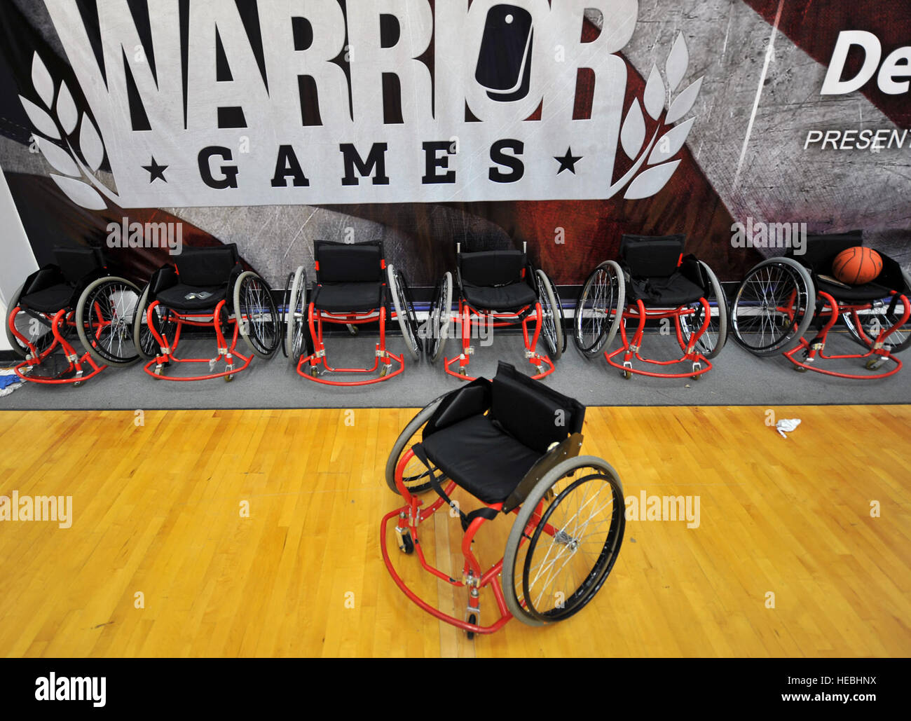 Wheelchairs lined up against a wall in the basketball court May 10