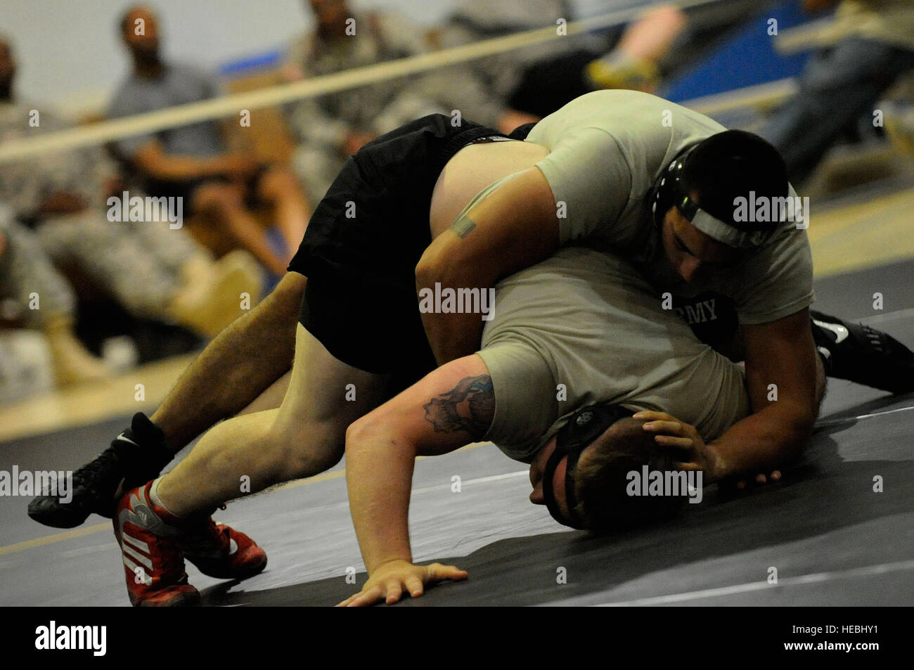 U.S. Army Soldiers with 1st Battalion, 67th Armored Regiment, 3rd Heavy Brigade Combat Team, 1st Cavalry Division, display their mat skills during a wrestling tournament at Forward Operating Base Marez, near Mosul, Iraq, July 25.  The three-day tournament features more than 75 competitors. Stock Photo