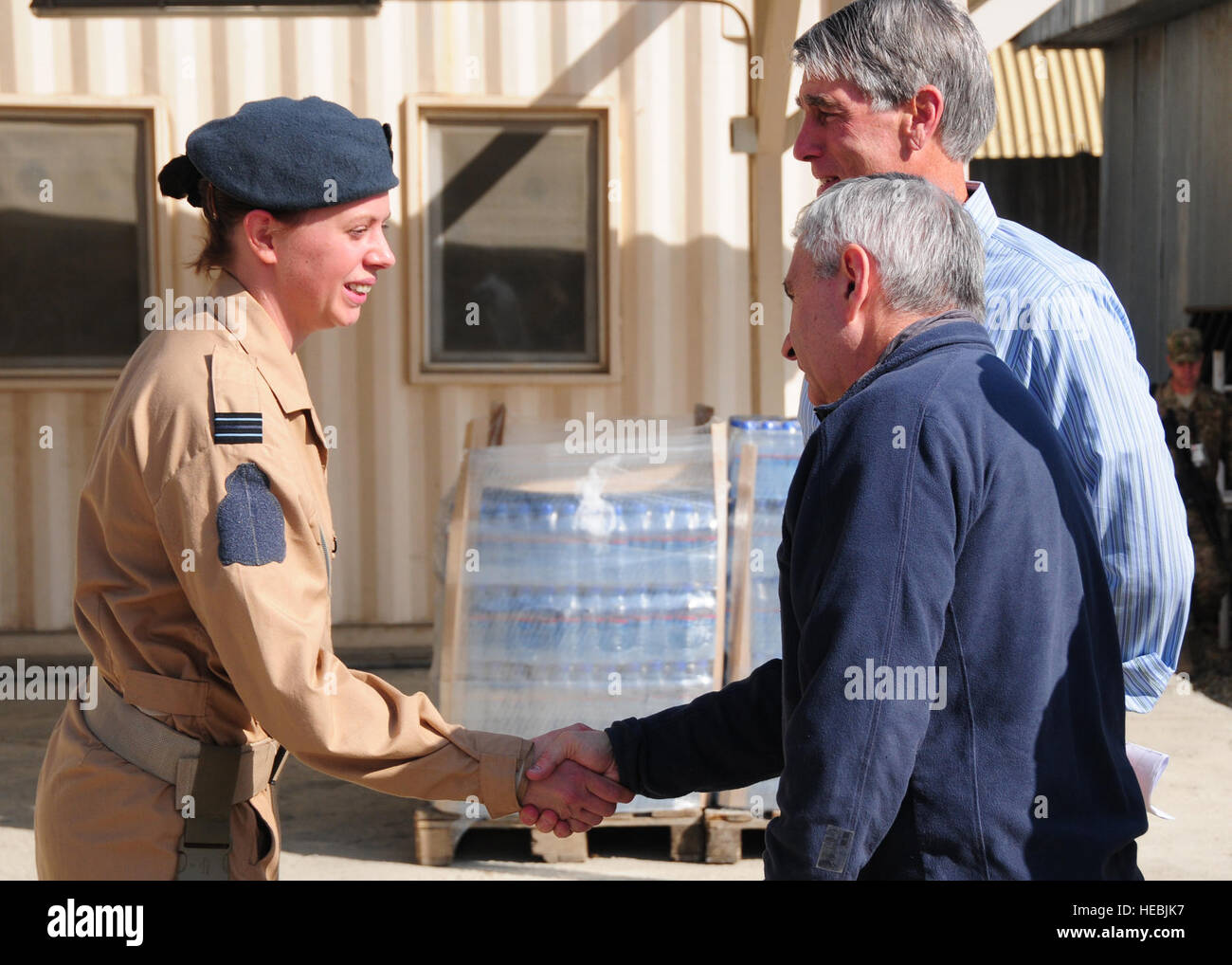 Royal Air Force Flight Lt. Ally McDowell, left, shakes hands with U.S. Sen. Jack Reed of Rhode Island in Thunder Lab at Kabul International Airport in Kabul, Afghanistan, Oct. 26, 2011. Thunder Lab was an English immersion program for Afghan officers to help prepare select trainees for pilot training. (U.S. Air Force photo by Senior Airman Amber Williams/Released) Stock Photo