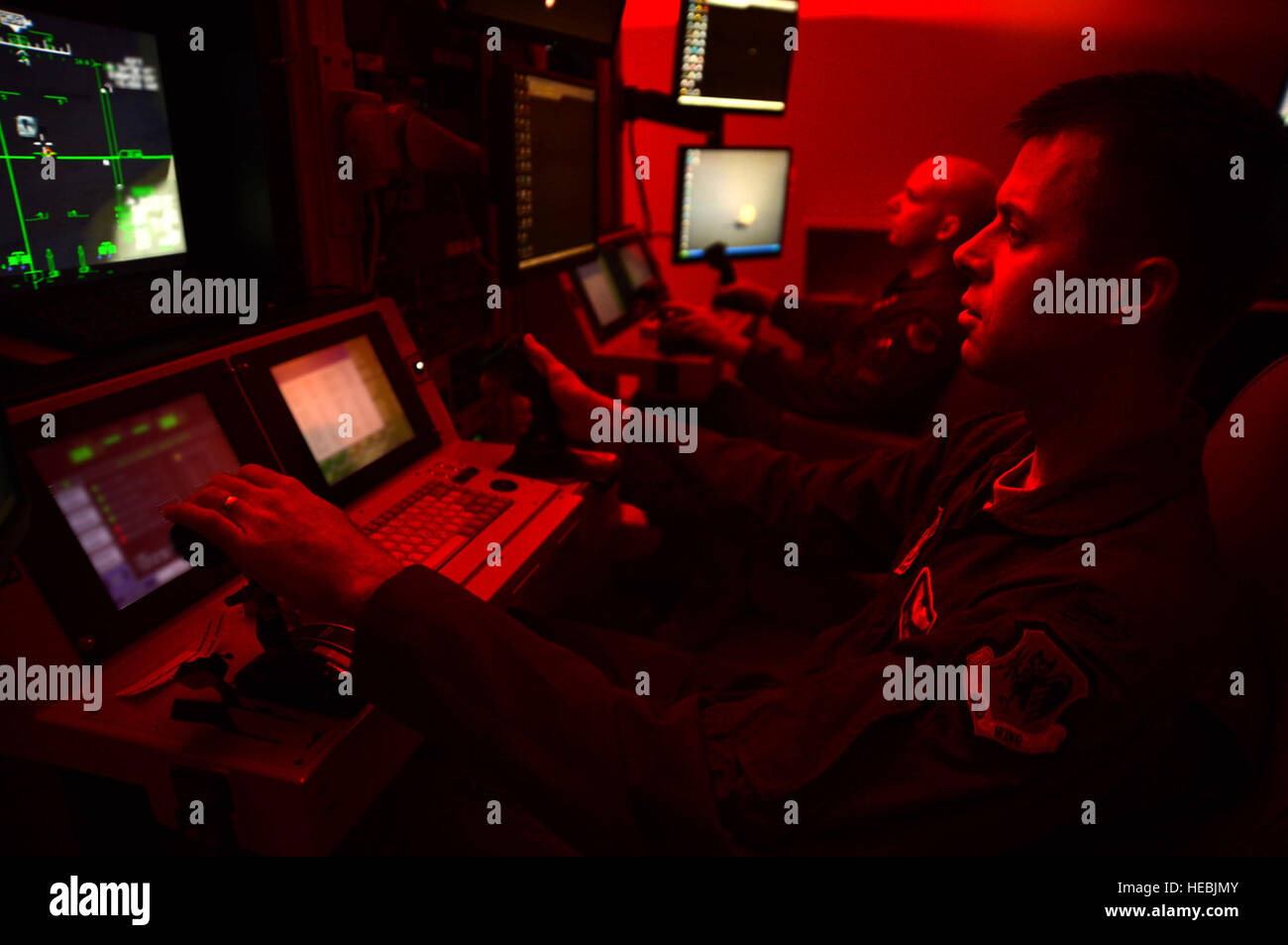 First Lt. Kyle, 91st Attack Squadron pilot, and Tech. Sgt. Jason, 91st ATKS sensor operator, fly a simulated training mission on an MQ-9 Reaper at Creech Air Force Base, Nev., May 8, 2014. The 91st ATKS was recently awarded the 2013 Grover Loening Trophy, which is presented annually to the all-around outstanding aviation program in the nation excluding combat rescue and special operations (Last names withheld for security purposes). (U.S. Air Force photo by Staff Sgt. N.B./Released) Stock Photo