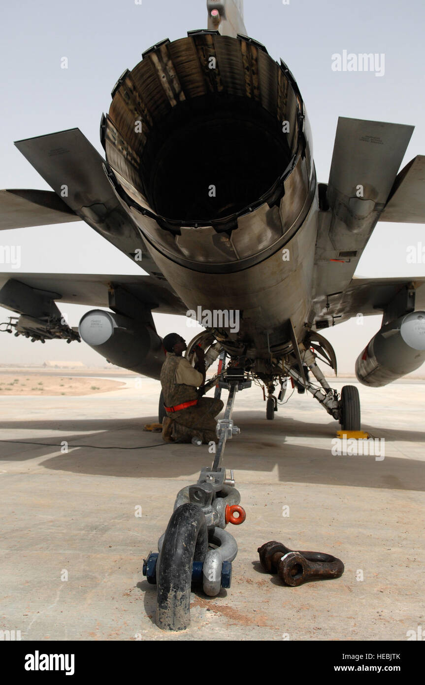 Staff Sgt. Keith Wright, a 77th Aircraft Maintenance Unit engine mechanic, screws in a panel on an F-16 Fighting Falcon before running up the engine here July 16. The run up of the engine back and forth from full afterburner to idle allows the engine mechanics and crew chiefs to ensure all systems are fully functional before putting the fighter back into operational use. Sergeant Wright is deployed from Shaw Air Force Base, S.C. Stock Photo