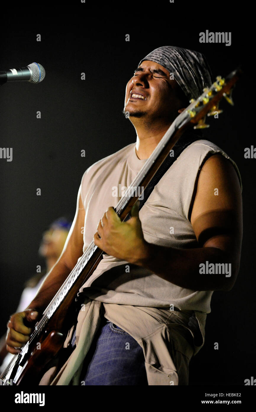 JoJo, bass guitar player for the Grammy Award winning Rock-N-Roll trio Los  Lonely Boys, grimaces as he plays during a music concert featuring the  Texas based band, at Contingency Operating Base Speicher