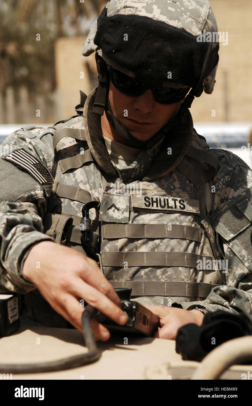 U.S. Army Spc. Justin Shults, a military policeman from 411th Military Police Company, 716th Military Police Battalion, 101st Airborne Division, reprograms a handheld radio in Abayachi, Iraq, March 30, 2008. (U.S. Air Force photo by Tech. Sgt. William Greer) (Released) Stock Photo
