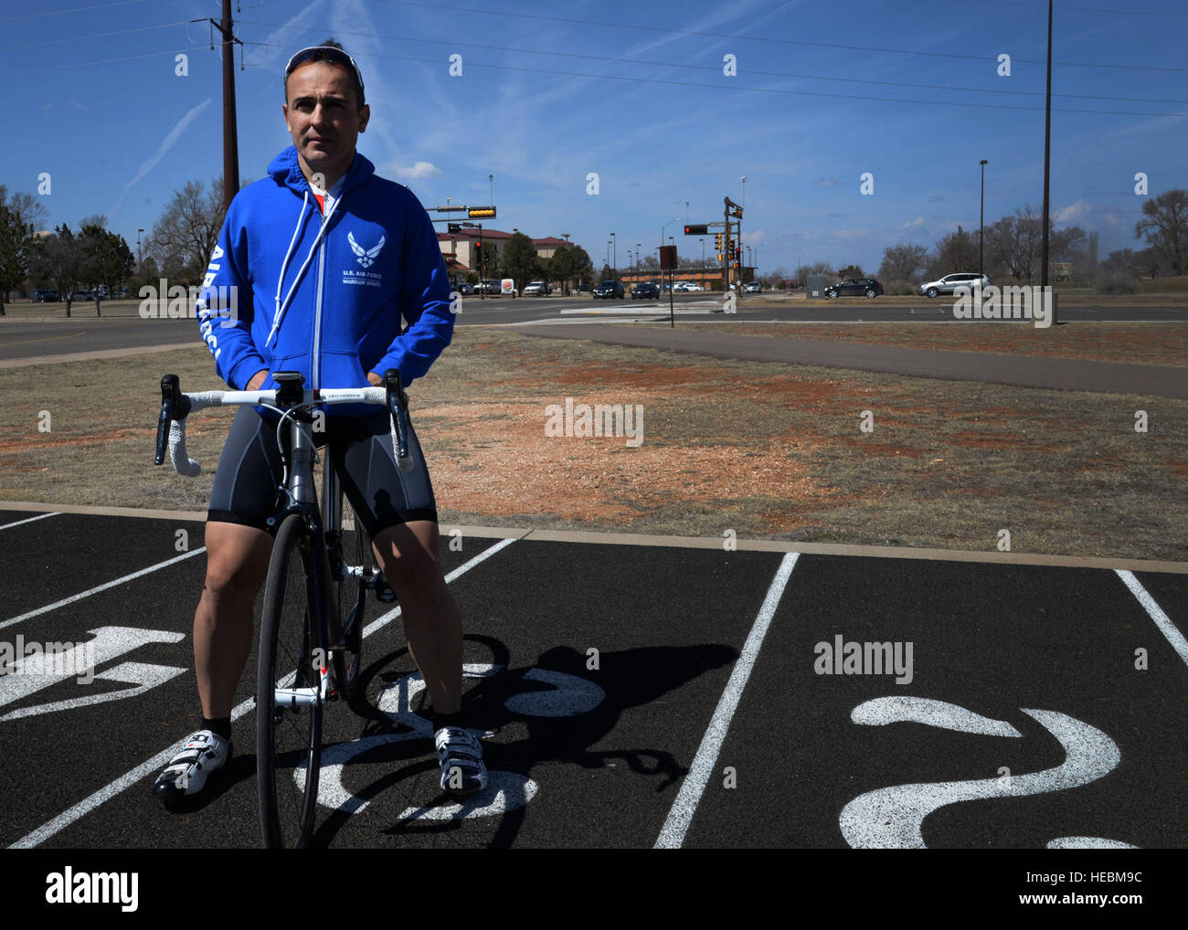 U.S. Air Force Maj. Joseph Williams, 27th Special Operations Medical Operations Squadron clinical medicine flight commander, poses on his bicycle at the base track March 13, 2015, at Cannon Air Force Base, N.M. Williams has found a way to mesh his profession with his passion through the Air Force Wounded Warrior Program, an organization dedicated to ensuring Airmen receive professional support and care from any point of injury, through separation or retirement, for life. (U.S. Air Force photo/Staff Sgt. Alex Mercer) Stock Photo