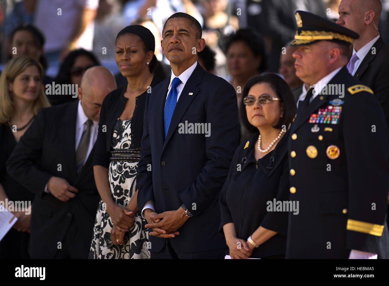 President Barack Obama listens in as the Army song is played in honor of Sen. Daniel K. Inouye at a Dec. 23, 2012 memorial service in Sen. Inouye's honor at the National Memorial Cemetery of the Pacific. Inouye was a U.S. Army World War II combat veteran with the 442nd Regimental Combat Team, who earned the nation's highest award for military valor, the Medal of Honor. Inouye became Hawaii's first congressman following statehood in 1959; he won election to the Senate in 1962. He was the first Japanese-American elected to both the House and Senate and was serving his ninth term in the Senate wh Stock Photo