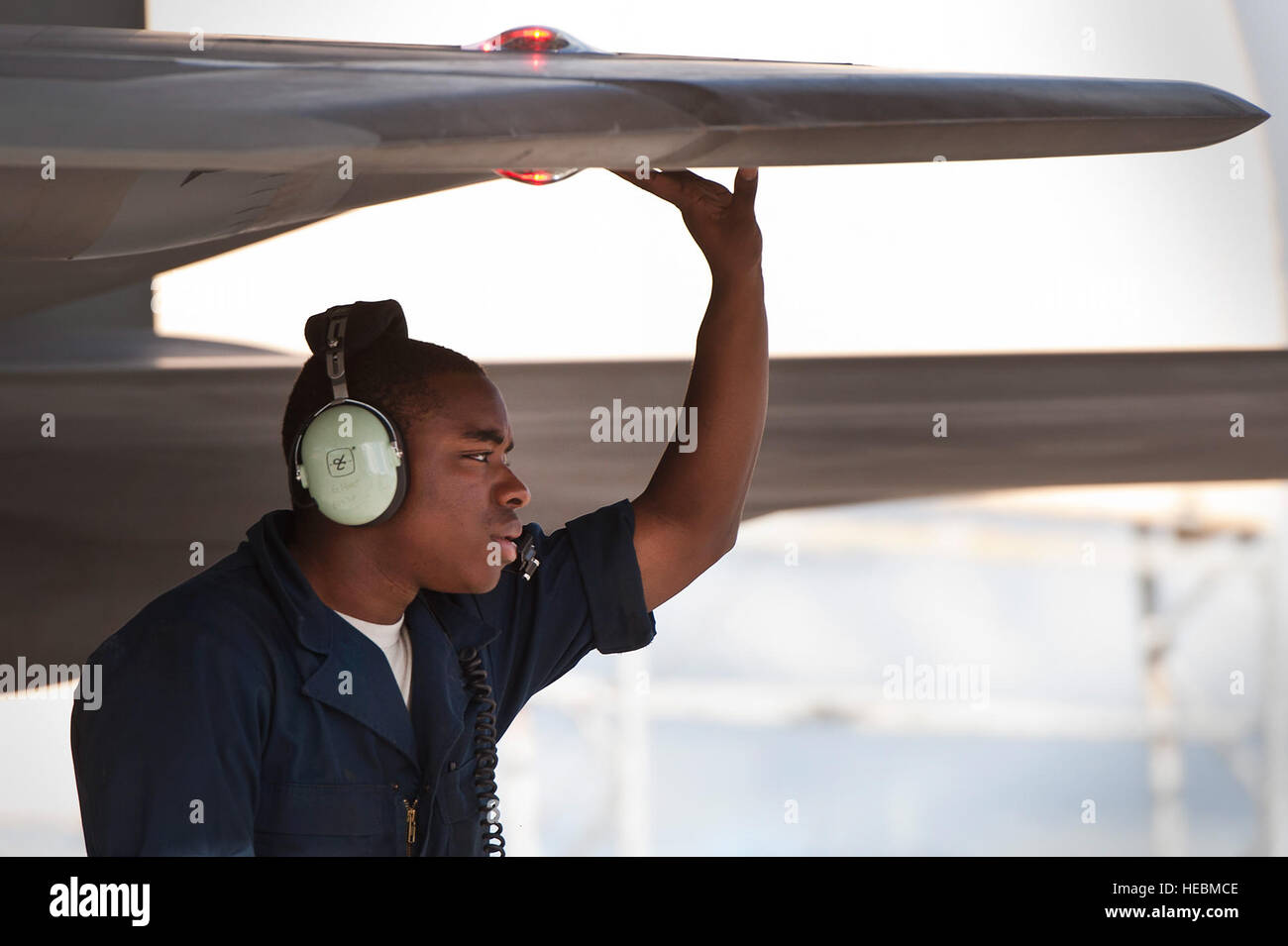 A U.S. Air Force airman, 199th Fighter Squadron, Hawaii Air National Guard, conducts pre-flight inspections for an F-22 Raptor during a Sentry Aloha exercise March 13, 2014, at Joint Base Pearl Harbor-Hickam, Hawaii. Sentry Aloha is an aerial combat exercise focused on offensive and defensive counter measures and fighter integration. Air National Guard, Air Reserves and active-duty airmen worked together during the training exercise. (U.S. Air Force photo by Staff Sgt. Christopher Hubenthal) Stock Photo