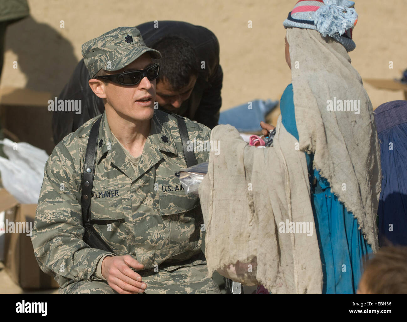 Lt. Col. (Dr.) Thomas Knolmayer gives and Afghan girl shoes at a