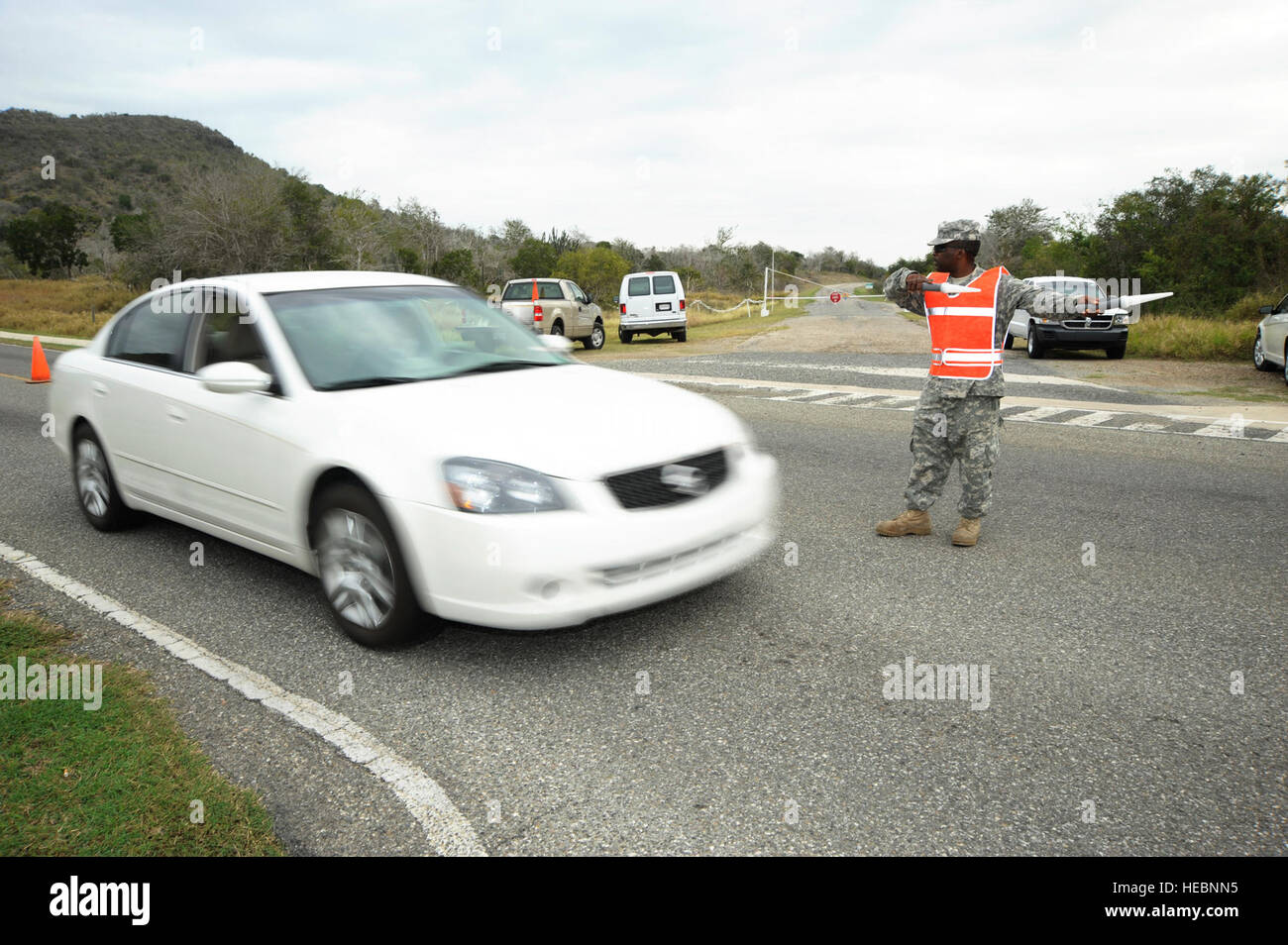 Army Sgt. Tashaia Bedminster, a Virgin Islands National Guardsman attached to Joint Task Force Guantanamo's maintenance transportation office, directs traffic during random inspections, March 4. Vehicles are inspected to ensure maintenance upkeep and adherence to policies. JTF Guantanamo conducts safe, humane, legal and transparent care and custody of detainees, including those convicted by military commission and those ordered released by a court. The JTF conducts intelligence collection, analysis and dissemination for the protection of detainees and personnel working in JTF Guantanamo facili Stock Photo