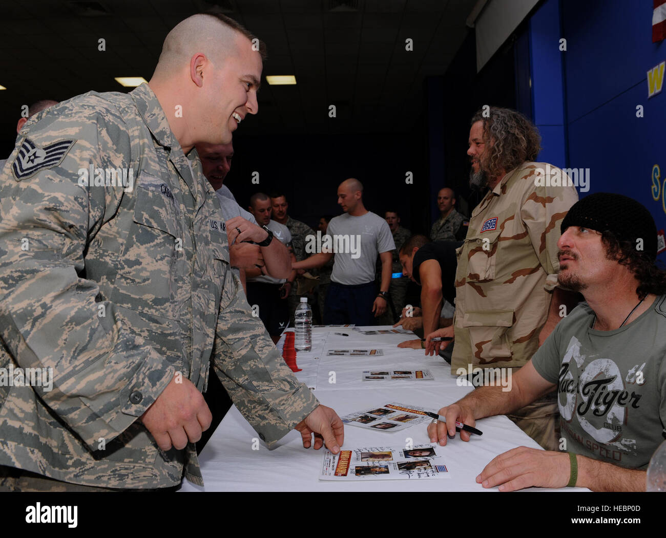 Tech. Sgt. Chris Cabano, an expediter with the 332nd Expeditionary Aircraft Maintenance Squadron, gets an autograph from Kim Coates, a cast member of Sons of Anarchy at a meet and greet event at Joint Base Balad, Iraq, March 15, 2010. Four cast members from the hit television show are touring bases throughout Southwest Asia to show their appreciation and provide a morale boost for deployed personnel. TSgt Cabano is deployed from Shaw Air Force Base, S.C. and is a native of Cabool, MS. (U.S. Air Force photo by Master Sgt. Linda C. Miller/Released) Stock Photo