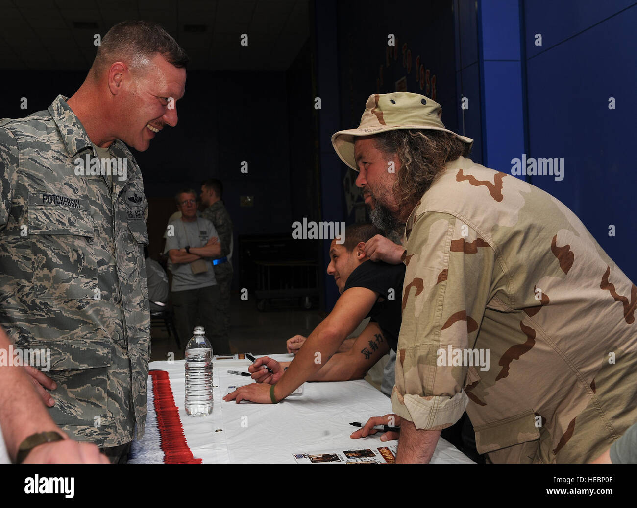 Senior Master Sgt. Ron Potchebski, 362nd Expeditionary Reconnaissance Squadron superintendent, talks with Mark Boone Junior, a cast member of Sons of Anarchy at a meet and greet event at Joint Base Balad, Iraq, March 15, 2010. Four cast members from the hit television show are touring bases throughout Southwest Asia to show their appreciation and provide a morale boost for deployed personnel. (U.S. Air Force photo by Master Sgt. Linda C. Miller/Released) Stock Photo