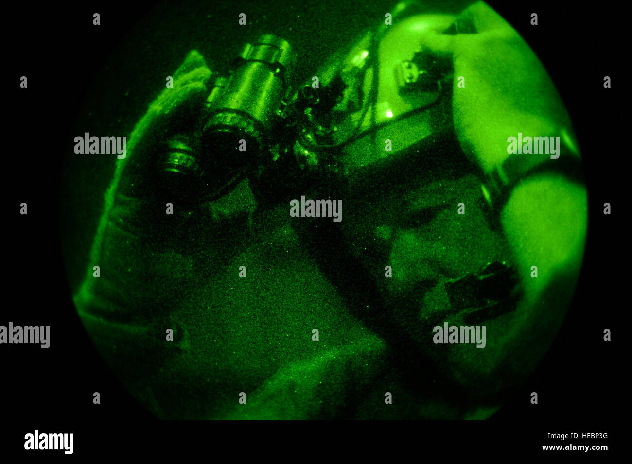 New York Air National Guard Master Sgt. Jerry Kurz, 102nd Rescue Squadron loadmaster, based at F.S. Gabreski Airport in Westhampton Beach, N.Y., adjusts his night vision goggles on board an HC-130P King during Exercise Southern Strike 15 (SS15) near the Combat Readiness Training Center (CRTC) in Gulfport, Miss., Oct. 30, 2014. SS15 is a total force, multiservice training exercise hosted by the Mississippi National Guard's CRTC Oct. 27 through Nov. 7, 2014. The SS15 exercise emphasizes air-to-air, air-to-ground and special operations forces training opportunities. These events are integrated in Stock Photo