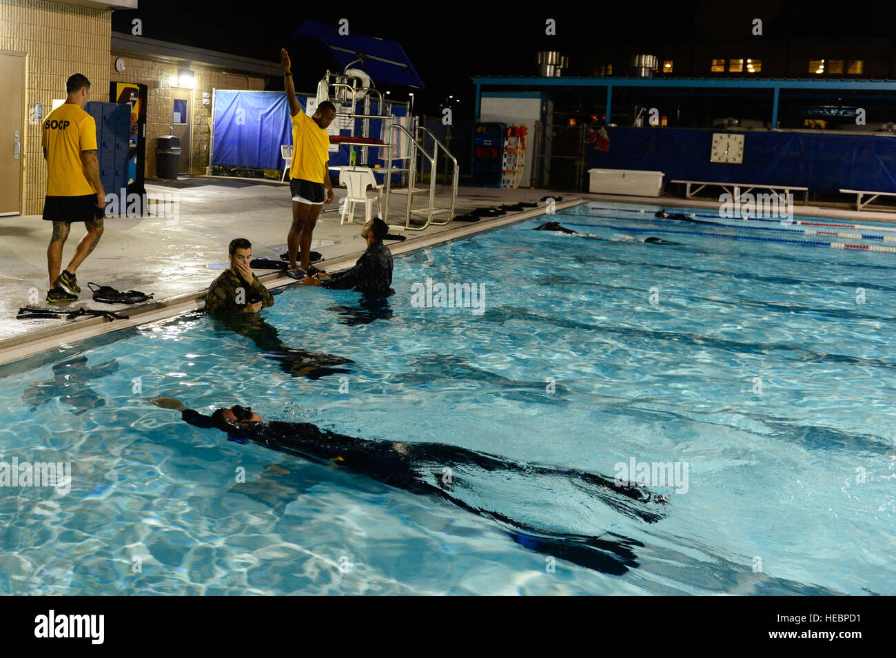 Instructors from the U.S. Navy Special Operations Corpsman Preparatory program provide one-on-one instruction with students while others swim laps in the Aquatic Center pool on Joint Base San Antonio - Fort Sam Houston, Texas, Aug. 12, 2013. The SOCP program is a 96-day course required for candidates applying for programs such as Special Amphibious Reconnaissance Corpsmen, Dive Medical Technician or Search and Rescue. (U.S. Air Force photo by Airman 1st Class Krystal Ardrey/Released) Stock Photo