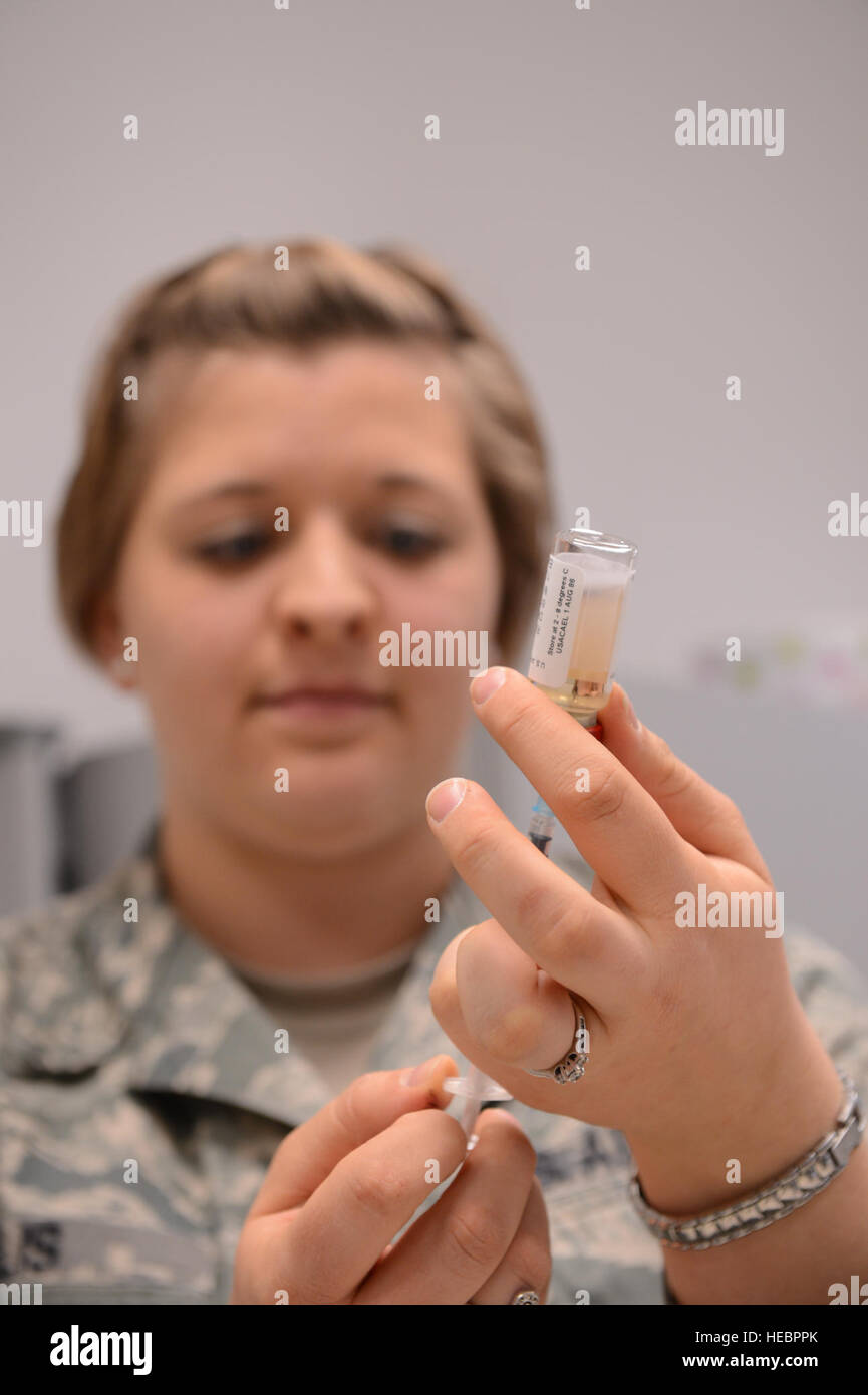 U.S. Air Force Staff Sgt. Sarah Ellis, 52nd Medical Operations Squadron noncommissioned officer in charge of allergy and immunizations from Mount Hood, Ore., April 2, 2013. Ellis fills a syringe with a vaccine to administer to a patient. Vaccines provide our airmen with the ability to fight off infectous diseases. (U.S. Air Force photo by Airmen 1st Class kyle Gese/Released) Stock Photo