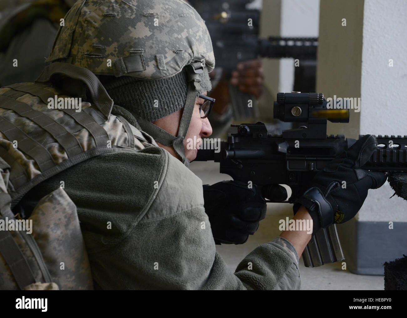 U.S. Air Force Airman 1st Class Angel Saenz, a 354th Civil Engineer Squadron water fuels system maintenance journeyman, fires an M4 carbine at the Combat Arms Training and Maintenance outdoor range Feb. 12, 2015, at Eielson Air Force Base, Alaska. Saenz attended an M4 requalification course. (U.S. Air Force photo by Senior Airman Ashley Taylor/Released) Stock Photo