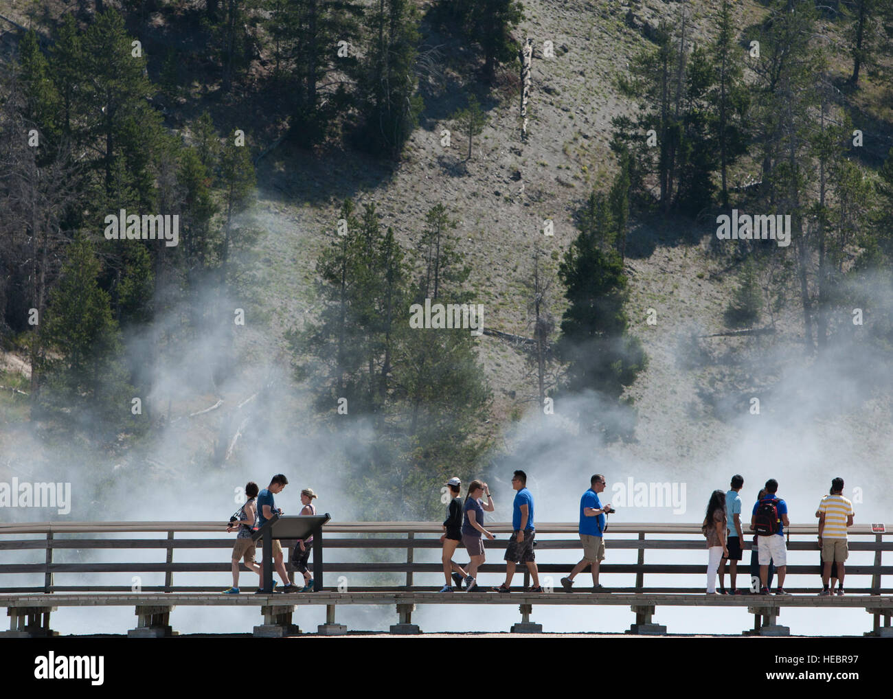 Crowds observe the Excelsior Geyser Crater from the safety of a boardwalk in Yellowstone National Park, Wyo., July 4, 2015. A visit to Yellowstone was part of an F.E. Warren Air Force Base Outdoor Recreation trip which included sightseeing some of the geological wonders of the park. (U.S. Air Force photo by Lan Kim) Stock Photo