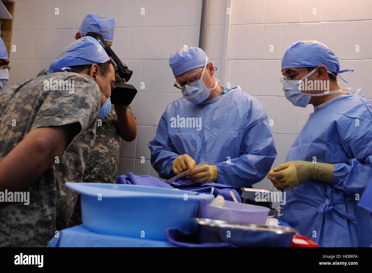 U.S. Army Maj. Christopher Shaffer, center, from Clearwater, Fla., with the 945th Forward Surgical Team, 10th Combat Support Hospital, trains an Iraqi surgeon on a skin graphing procedure, at Forward Operating Base Delta, Iraq, July 16. Stock Photo