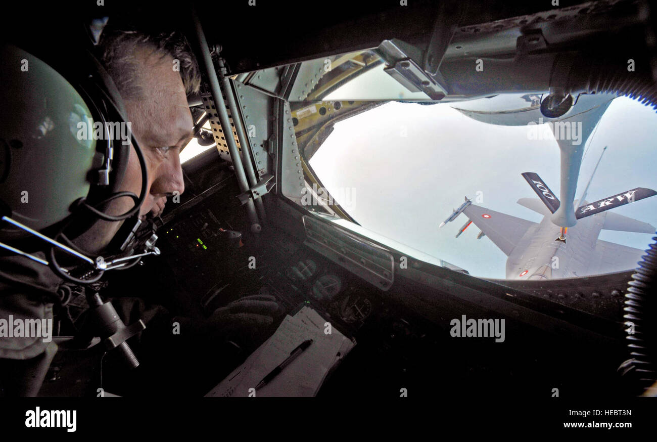 U.S. Air Force Master Sgt. Max Morkin, 100th Operations Support Squadron boom operator from Traverse City, Mich., transfers fuel in-flight from a KC-135 Stratotanker from RAF Mildenhall, England to an F-16AM aircraft from Skrydstrup Air Base, Denmark, Jan. 8, 2014, while flying over the North Sea. As a boom operator, Morkin is responsible for several tasks while in-flight, to include: in-flight refueling, ensuring appropriate safety equipment for passengers, and computing weight and balance data for takeoff and landing. (U.S. Air Force photo by Senior Airman Christine Griffiths/Released) Stock Photo