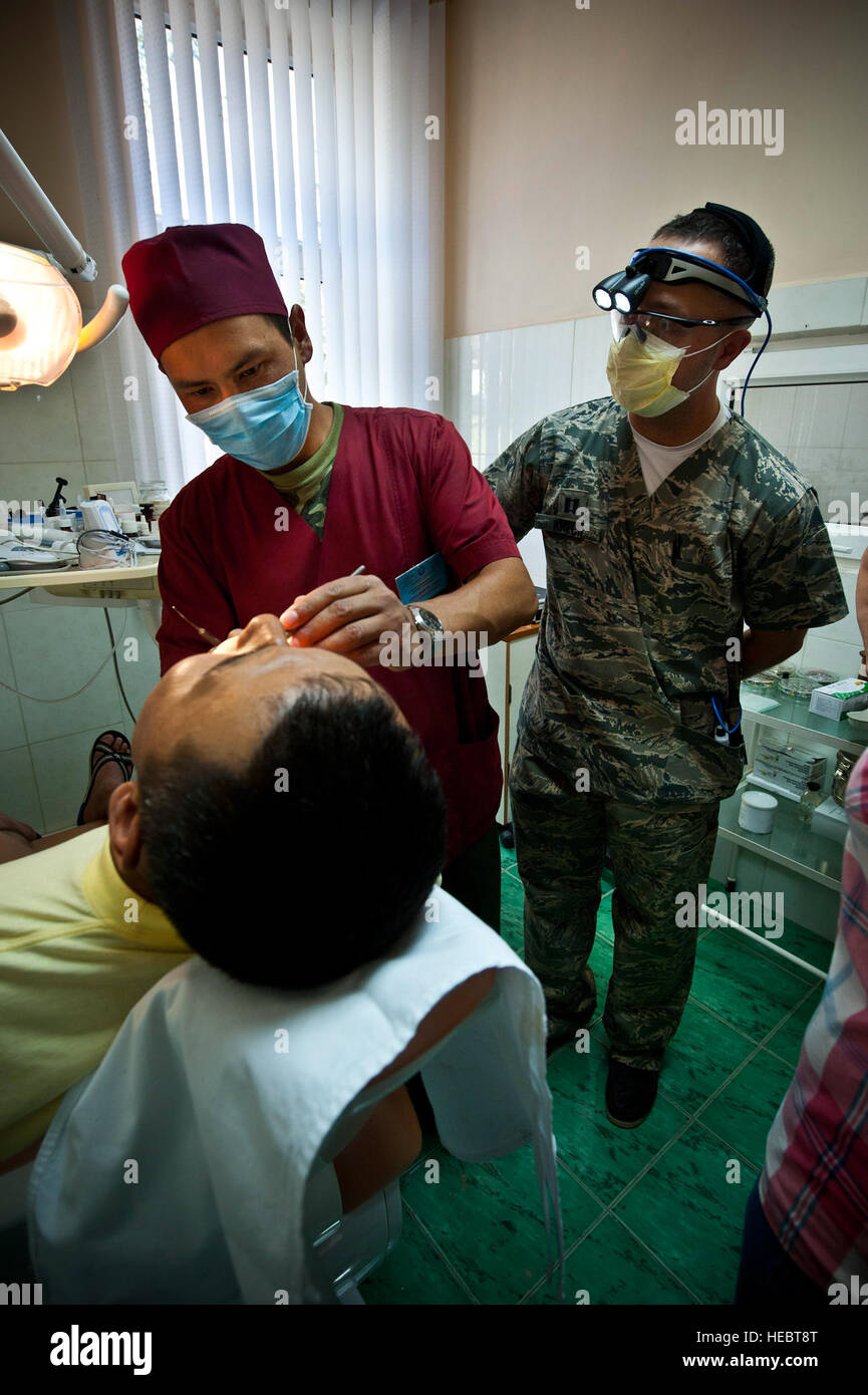 Right, Capt. Cody Krech observes Kyrgyz Republic Lt. Aibek Mamadiyarov while he searches for cavities during a dental exchange at the Besh Kungei Trauma Center, Kyrgyzstan, Aug. 16, 2012. The exchange highlighted the similar comparisons in dental craft and strengthened partnerships with Kyrgyz Republic military dentists. Krech is a 376th Expeditionary Medical Group dentist deployed out of Scott Air Force Base, Ill. and a native of Barlow, Ky. Stock Photo