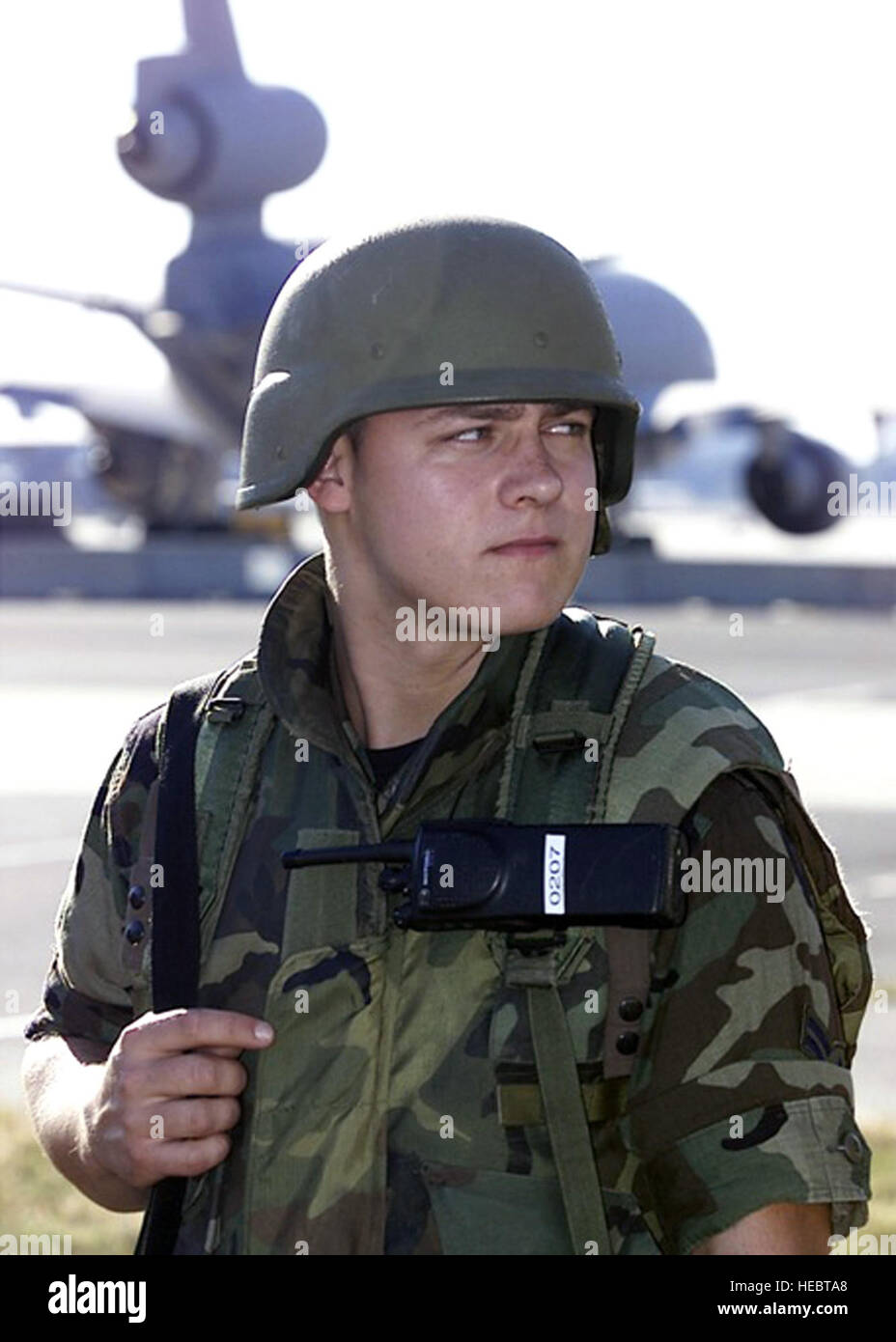 Airman First Class Thomas Messick of the 514th Security Forces Squadron, McGuire Air Force Base, N.J., guards the McGuire flightline on Sept. 11, 2001, in response to the terrorist attacks at the Pentagon, the World Trade Center of New York City and in Pennsylvania. In Air Mobility Command, the response to the attacks was immediate. At McGuire, now named Joint Base McGuire-Dix-Lakehurst, search and rescue teams and medical supplies were airlifted there by AMC aircraft and crews on Sept. 12. McGuire became the designated site by FEMA to house and feed urban search and rescue teams operating in  Stock Photo