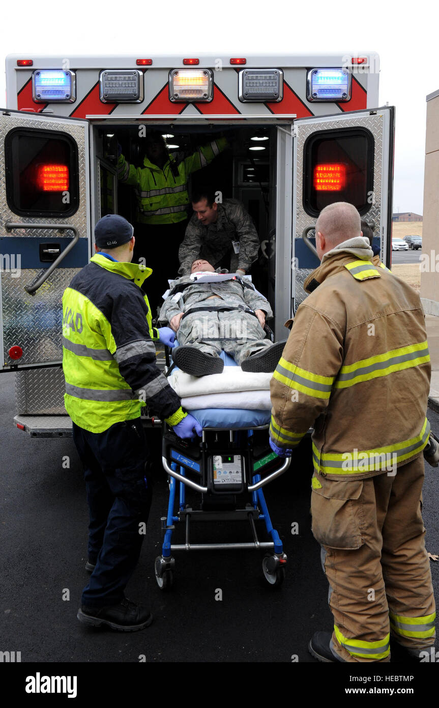 Senior Airman Derek Asbury, 509th Maintenance Group, is transported into the back of an ambulance during an active-shooter exercise at Whiteman Air Force Base, Mo., Feb. 11, 2015.  The Johnson County Ambulance District, from Warrensburg, Mo., also participated as local-civilian first responders during the exercise. (U.S. Air Force photo by Airman 1st Class Joel Pfiester/Released) Stock Photo