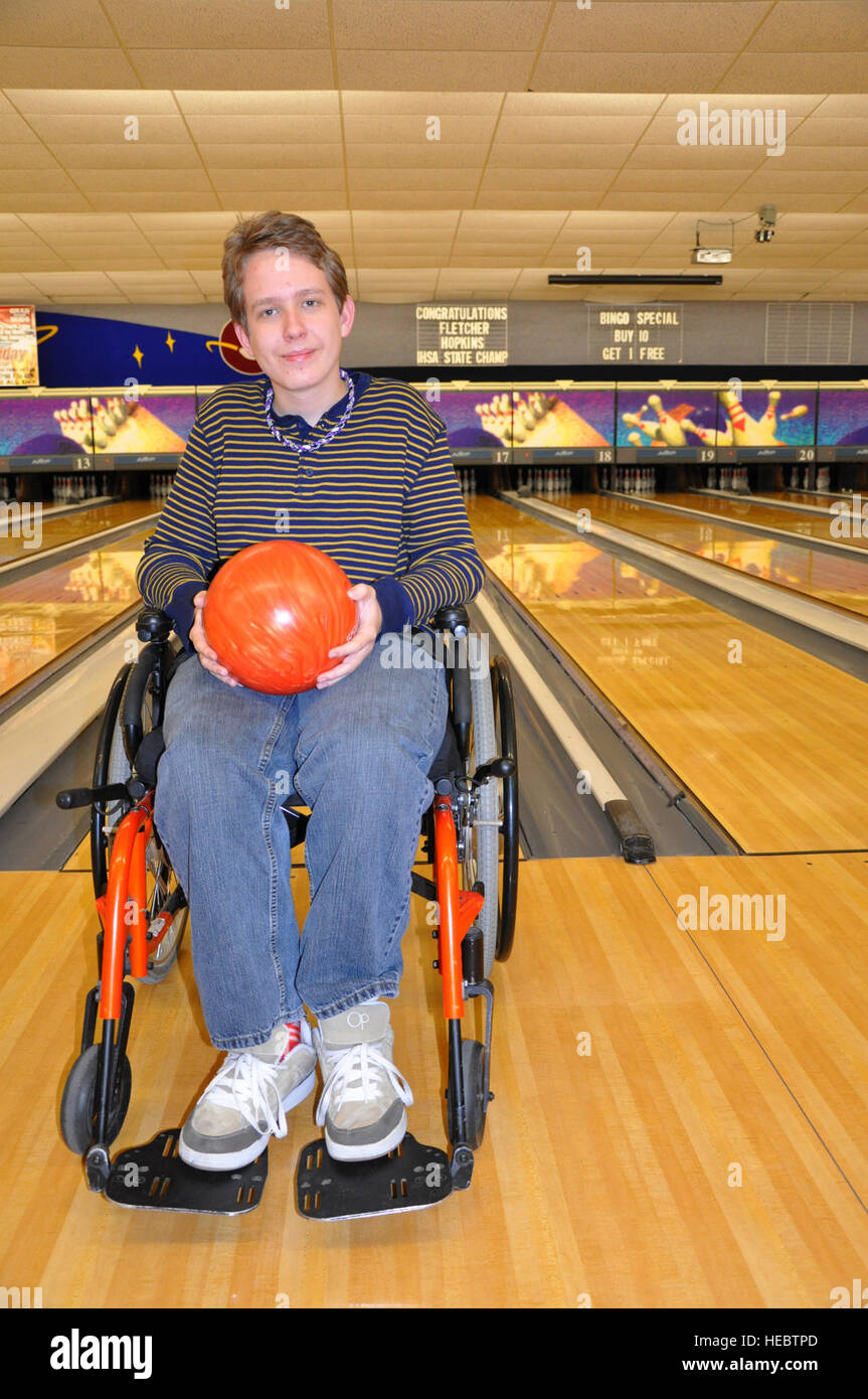 Fletcher Hopkins at the Scott Air Force Base, Ill., Stars and Strikes Bowling Center in front of the sign congratulating him for recently being named the Illinois High School Association Boys' Bowling Top Individual in the wheelchair division. Fletcher is a 15-year-old freshman at Mascoutah High School. (U.S. Air Force photo/Staff Sgt. Amber R. Kelly-Herard) Stock Photo