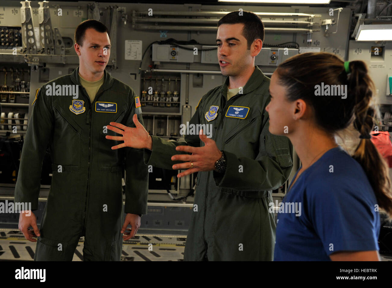 Senior Airman Cory Brashear, 14th Airlift Squadron loadmaster, and Capt. Thomas Carr, 14th AS pilot, give professional tennis player Lauren Davis, a briefing on the C-17 Globemaster III, April 1, 2014, at Joint Base Charleston, S.C. Lauren is a competitor in the Family Circle Cup tennis tournament on Daniel Island, S.C. (U.S. Air Force photo/Staff Sgt. Renae Pittman) Stock Photo