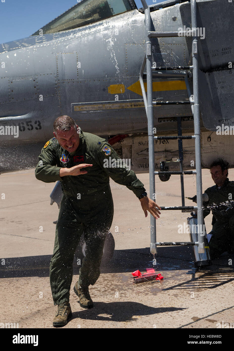 Lt. Col. Ronald King gets sprayed down with water after his first solo flight in the QF-4 Drone June 3, 2015, at Holloman Air Force Base, N.M. Lieutenant. Col. Ronald King, 82nd Aerial Target Squadron, Detachment 1 commander, flew the QF-4 for the first time solo, making him the last pilot in the Air Force that learned to fly the QF-4. He was accompanied by James  Harkins, a civilian pilot with the 82nd ATRS, Det 1, who also served as King’s instructor pilot at the U.S. Air Force Academy in the 1990s and at Luke Air Force Base, Ariz. in the early 2000s. (U.S. Air Force photo by Airman 1st Clas Stock Photo