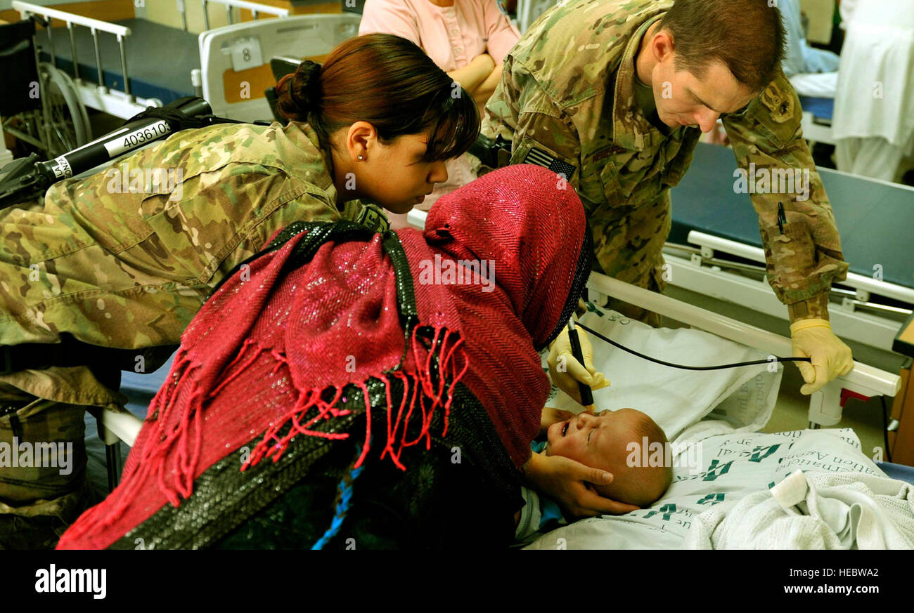 Maj. Marcus Neuffer, an ophthalmologist, and his technician Airman 1st Class Chellbie Gonzales conduct an ultrasound on the left eye of a 12-month-old boy July 7, 2013, in the Korean hospital at Bagram Airfield, Afghanistan. Neuffer is currently the only doctor at Bagram who is qualified to operate on eyes. Neuffer and Gonzales are with the 455th Expeditionary Medical Group. (U.S. Air Force photo/Staff Sgt. Stephenie Wade) Stock Photo