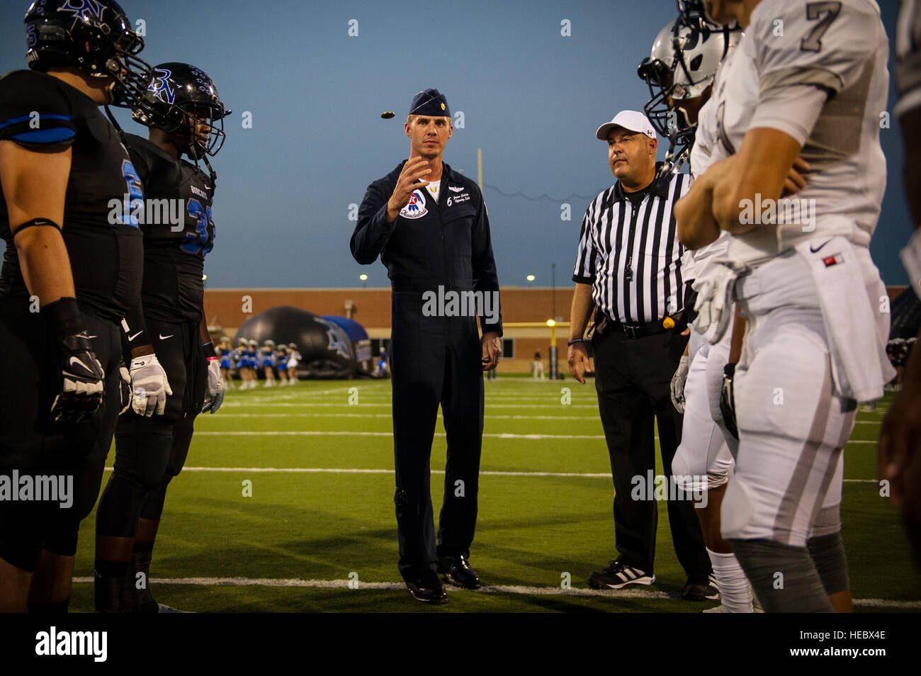 Maj. Jason Curtis, Thunderbird 6, performs the coin toss to start a high school football game at Forth Worth, Texas, Oct. 24, 2014. (U.S. Air Force photo/Tech. Sgt. Manuel J. Martinez) Stock Photo