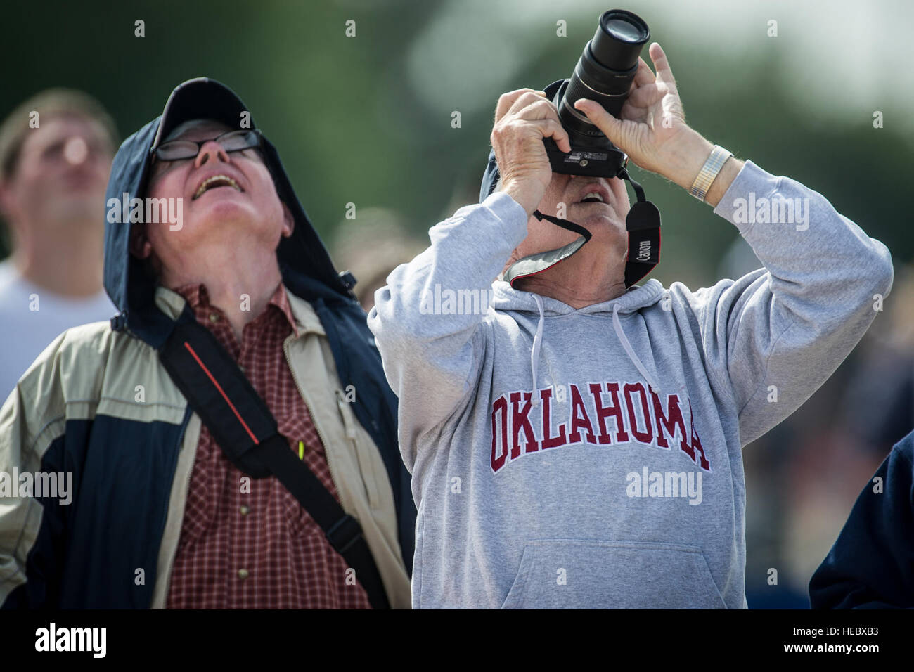 Thunderbirds fans look on with delight and cameras ready during the demo pilots’ precision maneuvers at the Wings of Freedom Open House and Air Show, Altus Air Force Base, Okla., Sept. 13, 2014. (U.S. Air Force photo/Master Sgt. Stan Parker) Stock Photo