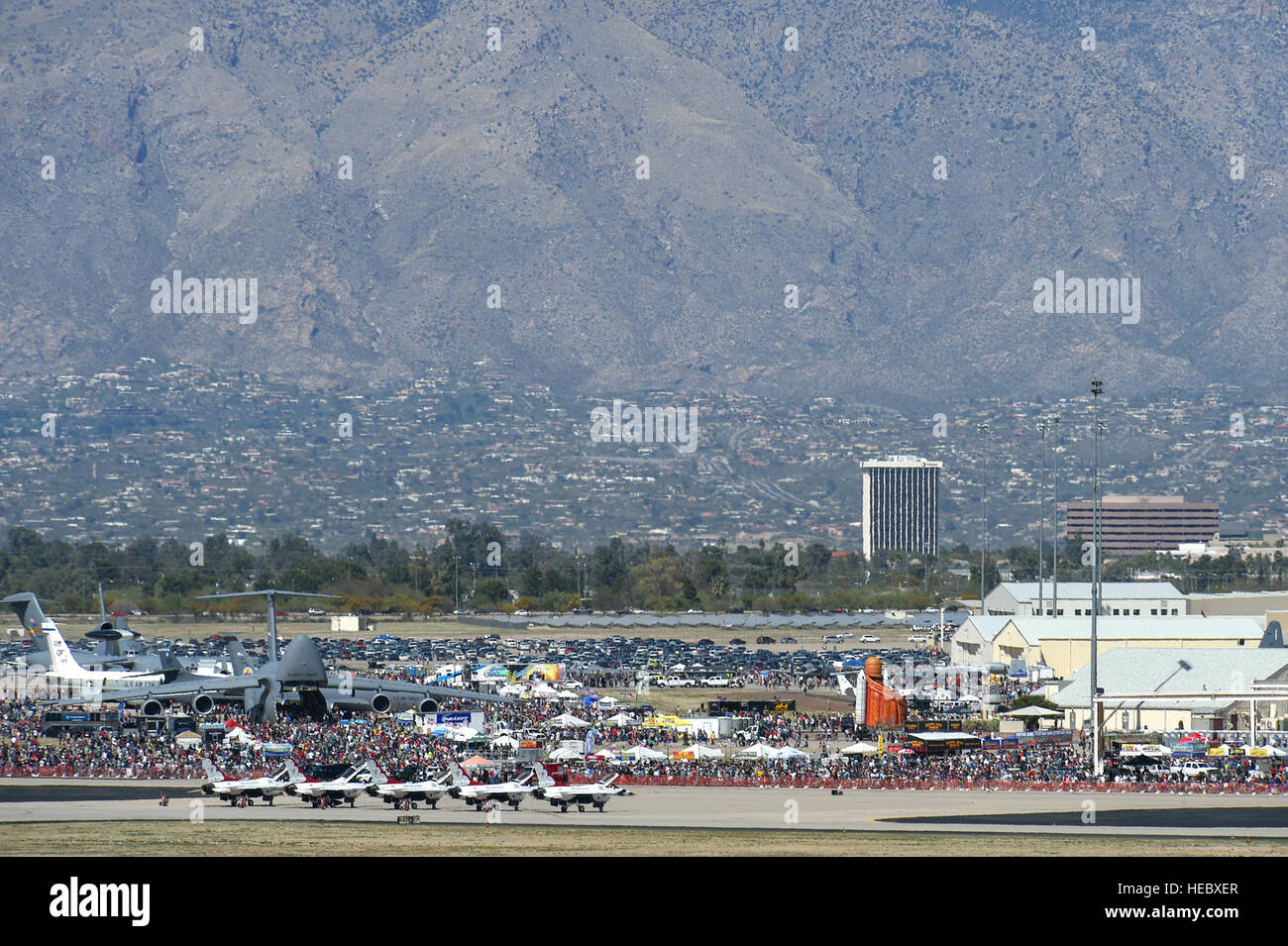 Thousands of attendees gather to watch aerial demonstrations and look at static displays on the flightline during the Thunder and Lightning over Arizona Open House at Davis-Monthan Air Force Base, Ariz., March 12, 2016.  The base opened its doors for the free event to showcase military air power and express appreciation for the local community's continuous support of D-M's missions. (U.S. Air Force photo by Senior Airman Chris Massey/Released) Stock Photo