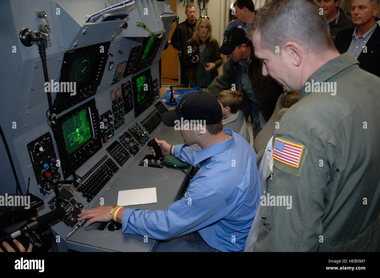 HURLBURT FIELD, Fla., -- Tech. Sgt. Robert Ryan, 19th Special Operations Squadron, shows Mr. Tim Tebow, Univ. of Florida quarterback, how to operate the sensors and how to shoot the 25mm Gatlin Gun on a AC-130U Infrared Sensor station during his visit, Feb. 20. Mr. Tebow along with Danny Wuerffel, former NFL quarterback, and Boo Weekley, pro golfer, visited Hurlburt Field to boost the morale of the Airman stationed here. (U.S. Air Force photo/Senior Airman Sheila DeVera)(RELEASED) Stock Photo
