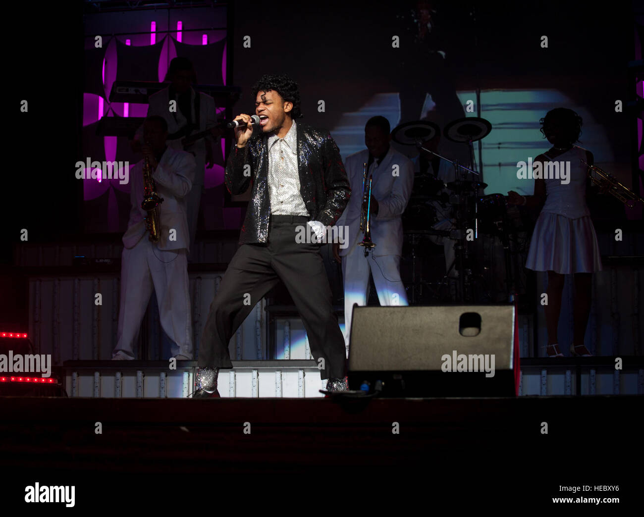 Staff Sgt. Tyron Jones dresses as Michael Jackson as he sings with the Tops in Blue Jan. 9, 2013, at the North Charleston Performing Arts Center, S.C. Composed of vocalists, musicians, dancers and technicians, their primary mission is to perform for military personnel and their families throughout the world. (U.S. Air Force photo/Airman 1st Class Ashlee Galloway) Stock Photo