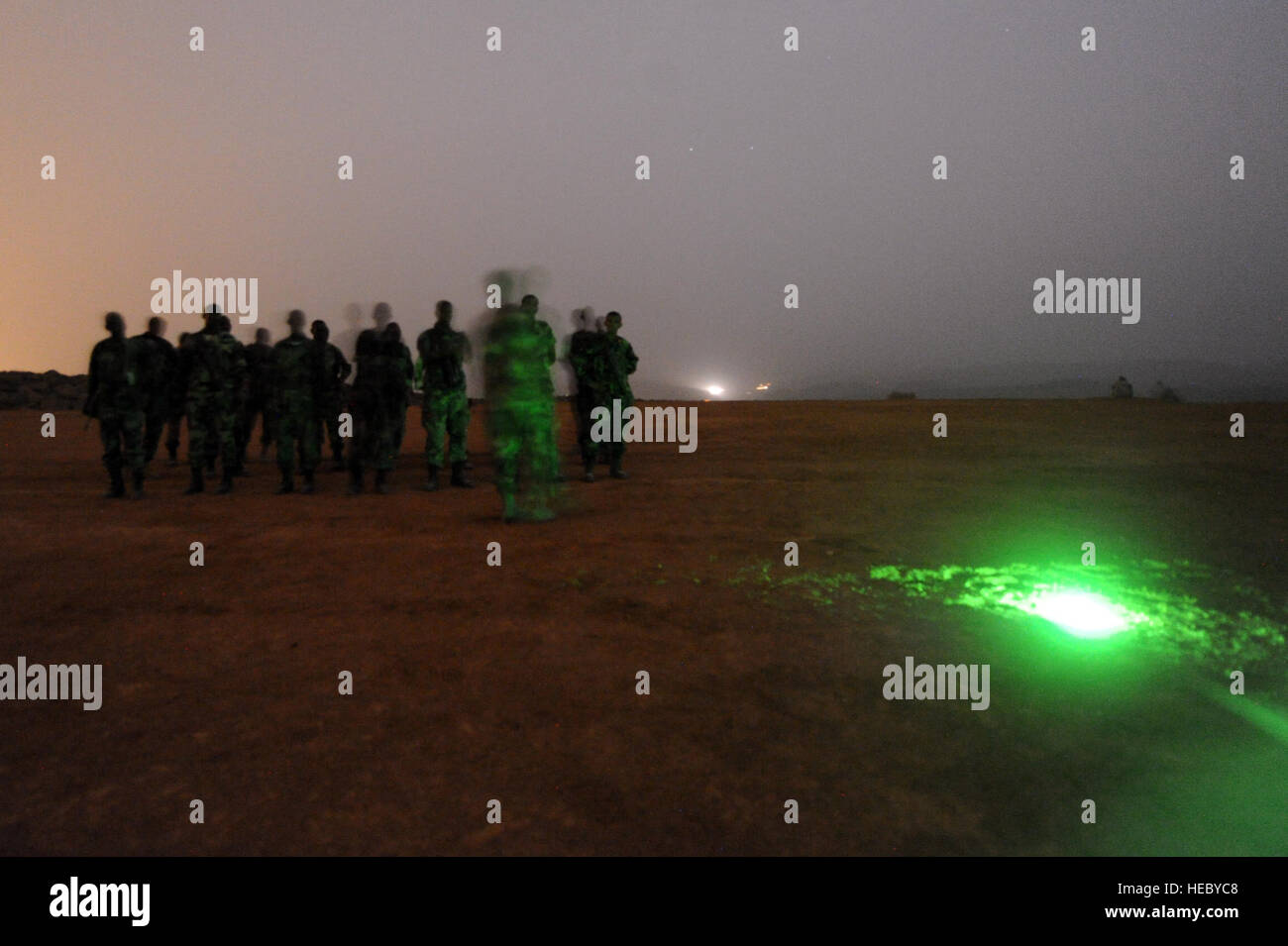 Djiboutian army soldiers wait at a start point during a night vision goggle class in Arta, Djibouti, on March 25, 2012. The U.S. Army's 3rd Squadron, 124th Cavalry Regiment, deployed in support of Combined Joint Task Force - Horn of Africa (CJTF-HOA), is helping train Djiboutian army soldiers for an upcoming deployment to Somalia. Stock Photo