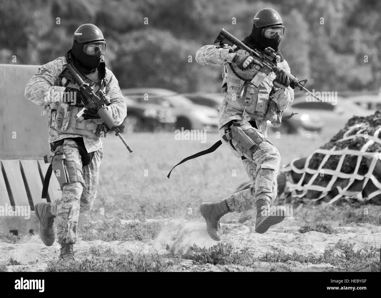 Two Airmen from the 96th Security Forces Squadron run for cover during