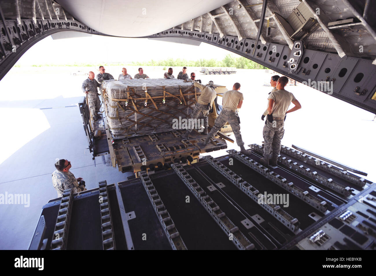 As part of the cargo shipments from Transit Center at Manas, Airmen stack empty surplus pallets on a C-17 Globemaster III, May 20, 2014.  Technical Sgt. Edgardo Franco, air transportation craftsman, Senior Master Sgt. Shawn Walker, superintendent of knowledge operations,  Col. John Vaughn, 376th Air Expeditionary Wing vice commnader, Chief Master Sgt. Gregory Warren, 376th AEW command chief, Senior Airman Kody Novak, air transportation journeyman, Staff Sgt. Jon Luna, air transportation craftsman, Staff Sgt. Lucas Hofstra, air transportation craftsman, Senior Master Sgt. Mark Foreman, Air Term Stock Photo