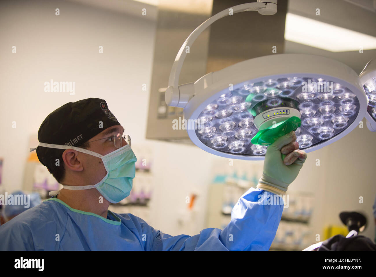 A U.S. Airman assigned to the 455th Expeditionary Medical Group adjusts the lights during surgery on an Afghan National Defense and Security Forces soldier who sustained trauma from a gunshot at the Craig Joint Theater Hospital, Bagram Air Field, Afghanistan, Sept. 26, 2015. The CJTH provides surgical capabilities in trauma, general surgery, orthopedics, neurosurgery, urology, vascular surgery and otolaryngology, all of which are critical to helping 98 percent of patients who come to the hospital survive their injuries. (U.S. Air Force photo by Tech. Sgt. Joseph Swafford/Released) Stock Photo