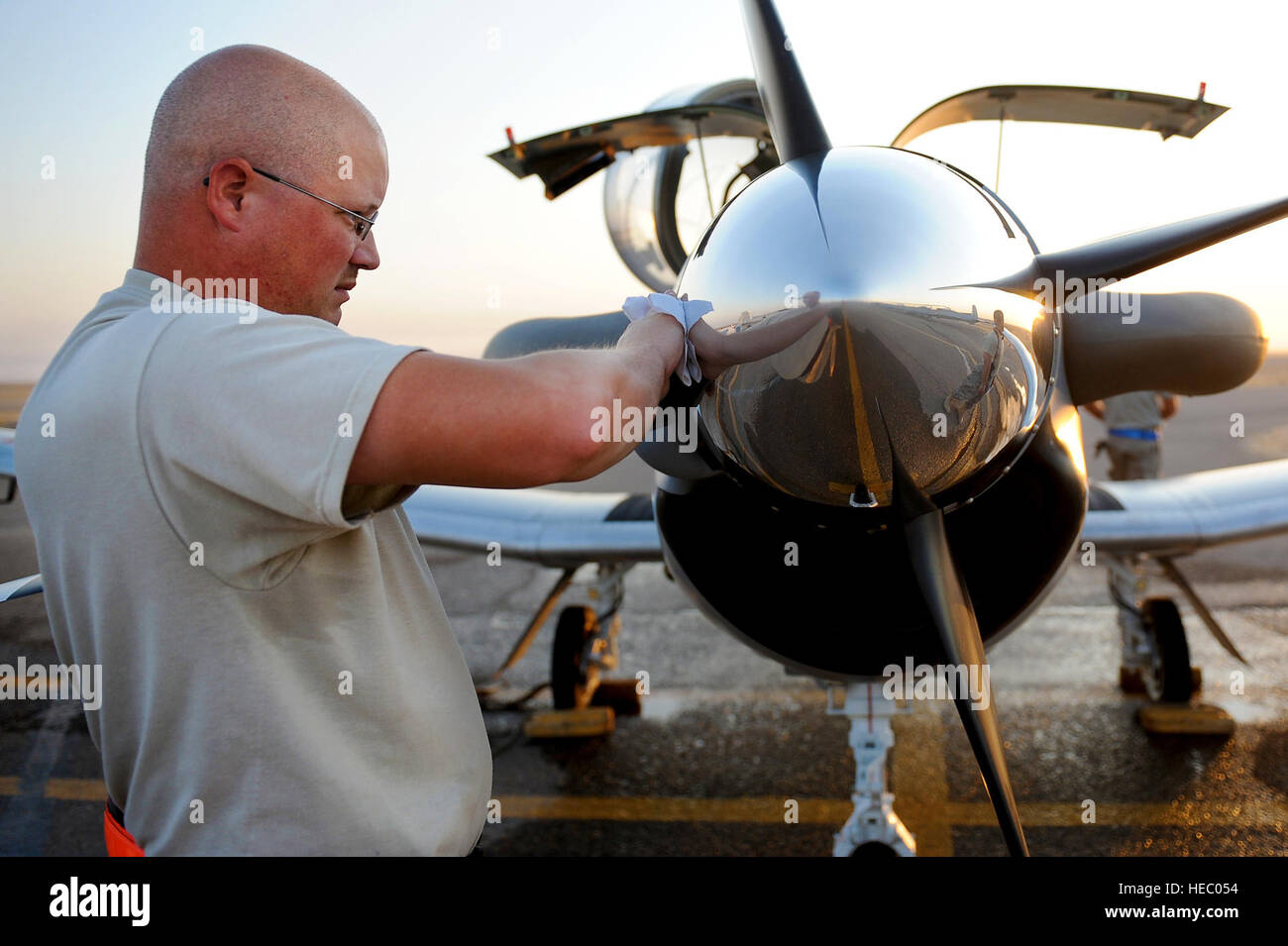 Tech. Sgt. Wayne Morris, 52nd Expeditionary Flying Training Squadron maintenance advisor, shines the nose cone of a T-6 Texan II aircraft for one of the last joint training missions with the IqAF Squadron 203 Sept. 4, 2011, at Camp Speicher, Iraq. The 52nd EFTS turned over flight operations to the Iraqi air force Sept. 5. Morris is deployed from Dyess Air Force Base, Texas, and hails from Toronto, Ohio. Stock Photo