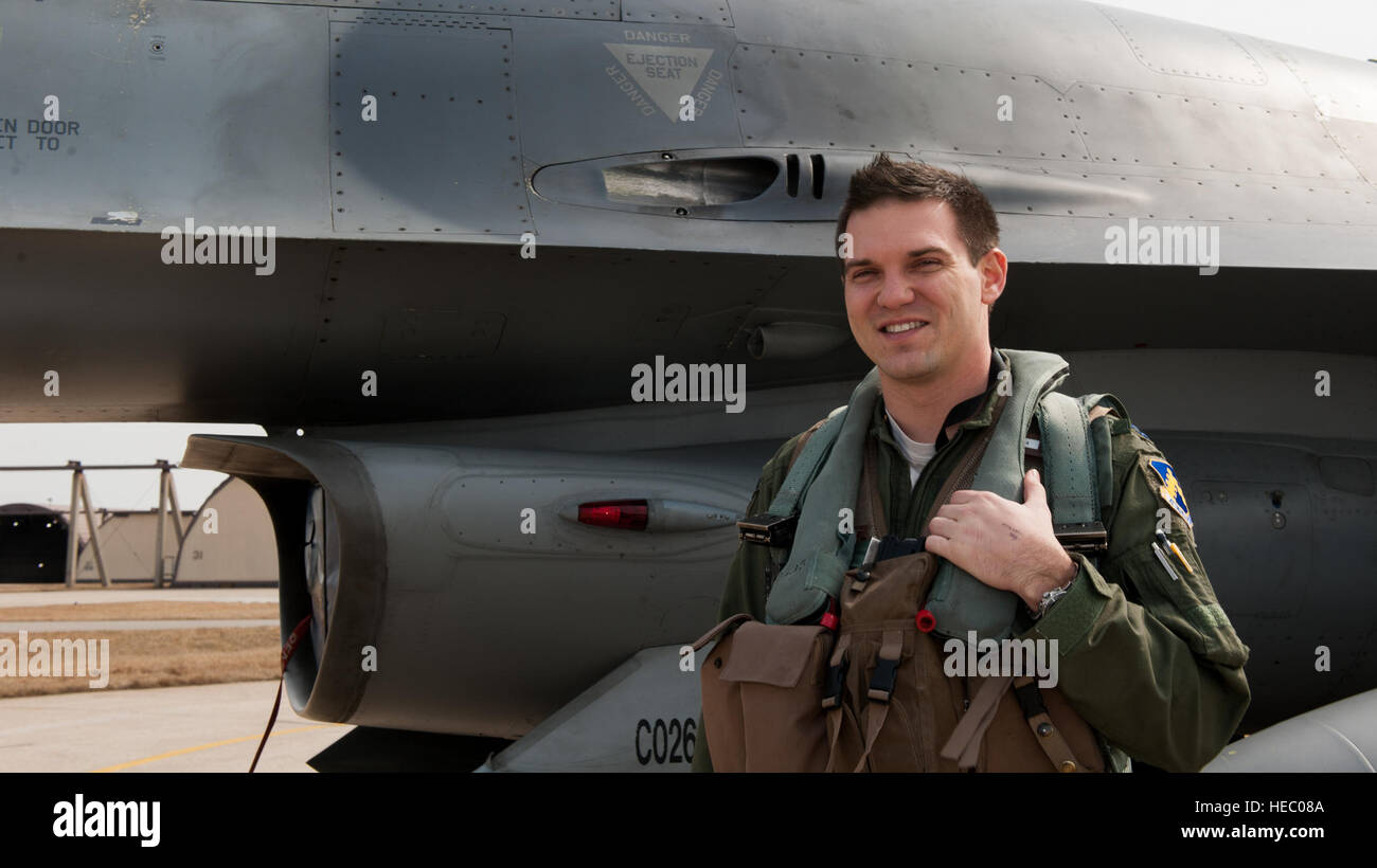 Capt. Mark Vahle, 8th Operations Group standardization and evaluation chief, poses beside an F-16 Fighting Falcon at Kunsan Air Base, Republic of Korea, March 5, 2014. Vahle was one of two Wolf Pack pilots accepted into the Air Force’s test pilot school, where students are trained and tested on their ability to adapt and become an Air Force test pilot. (U.S. Air Force photo by Senior Airman Armando A. Schwier-Morales/Released) Stock Photo