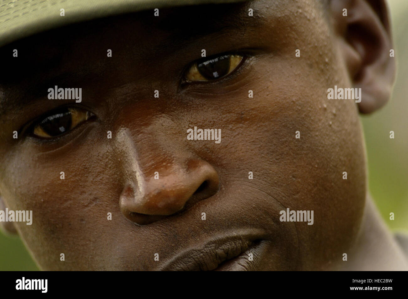 Using a compass, a Uganda Army soldier searches the terrain for several