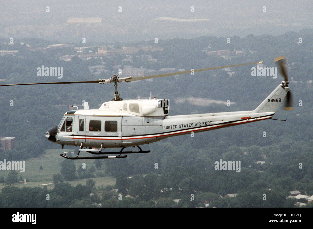 An air to air left side view of an Air Force UH1 Iroquois helicopter
