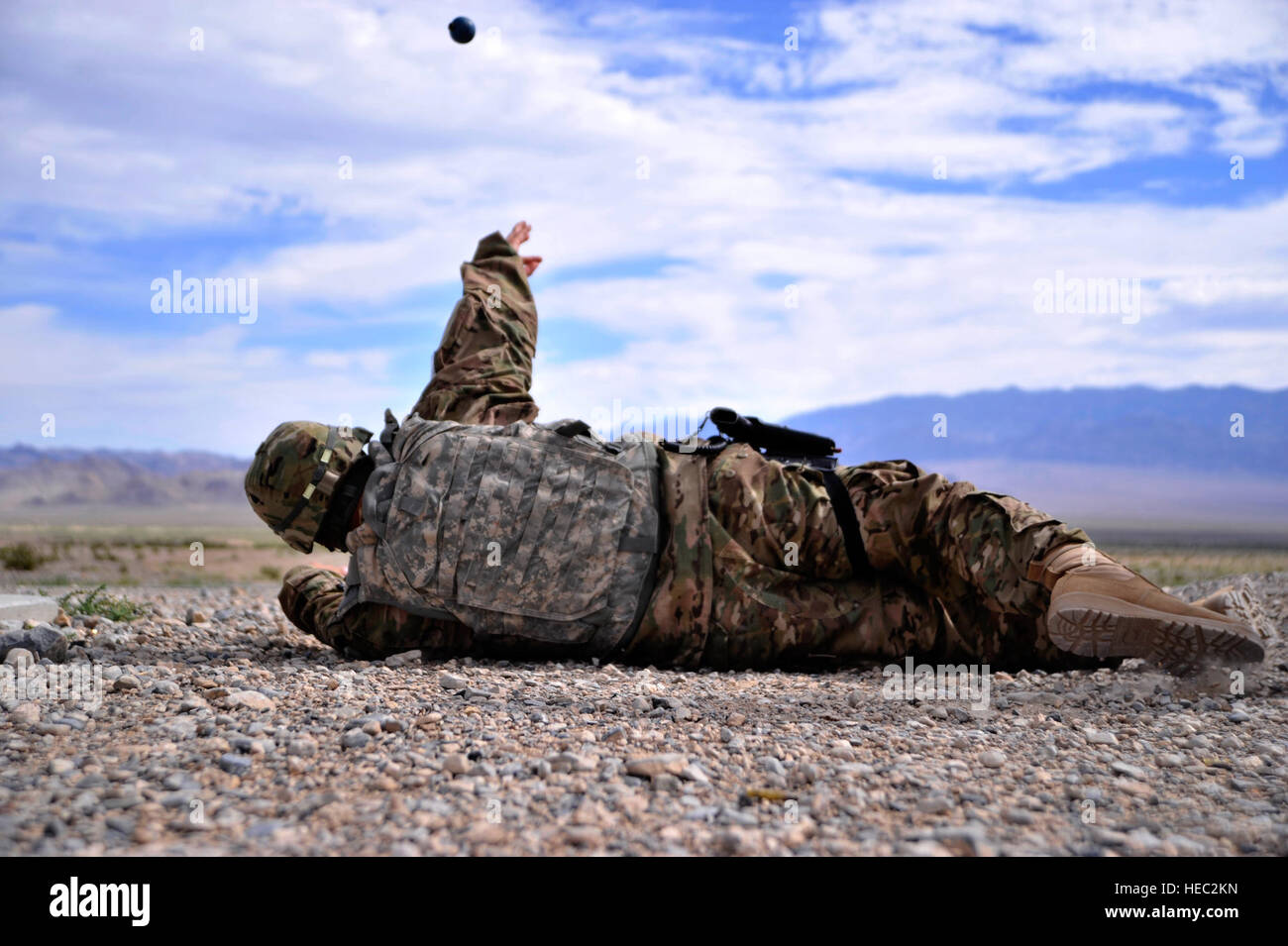 A military member throws an M-69 practice grenade during the final ...