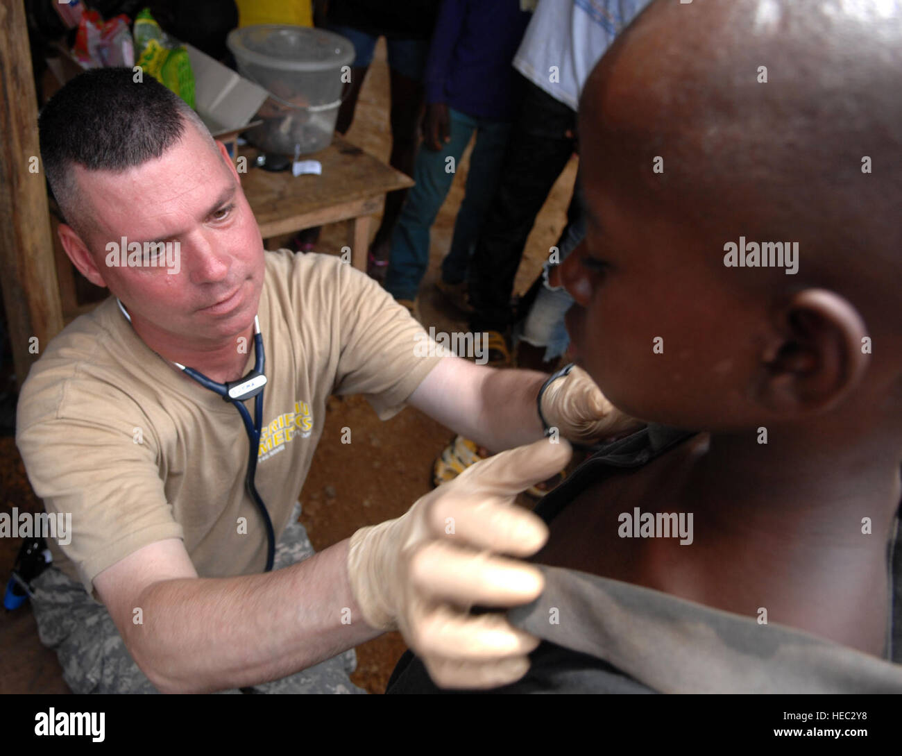 U.S. Army Sgt. 1st Class Robert Gutman, a field medic deployed with Operation ONWARD LIBERTY from Ypsilanti, Mich., performs a physical examination on a child during a medical outreach visit to Gondor Town, Liberia, July 2, 2013. The AFL led a 14-person medical outreach team including doctors, nurses and a support staff to three villages deep in the jungles of Grand Cape Mount County, Liberia, from July 1 to July 4, 2013. The medical outreach mission was a first for the AFL which was restructured in 2005 following 15 years of civil war. OOL advisors have been mentoring the AFL since 2010.  OOL Stock Photo