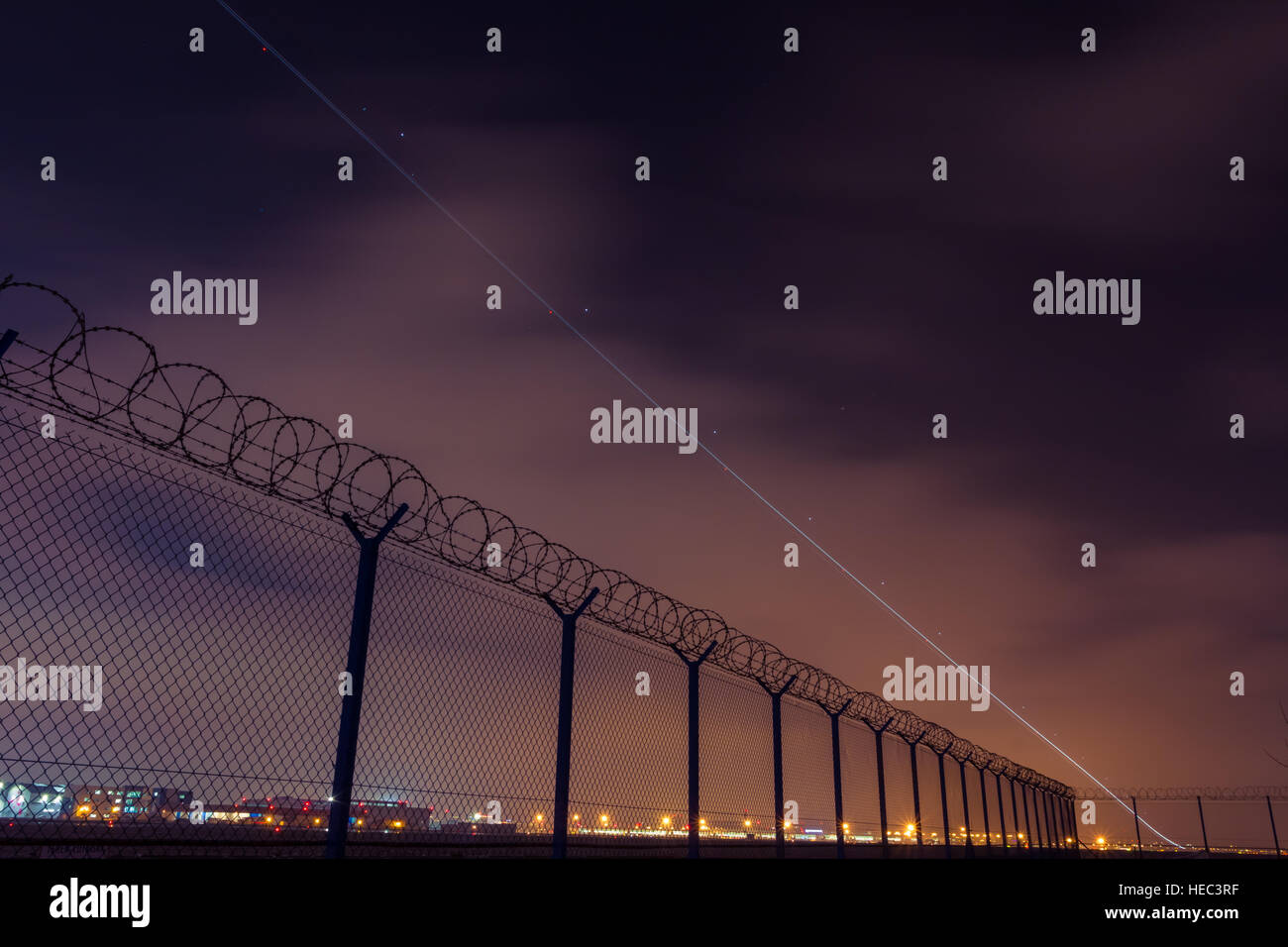 Take off of commercial airliner from international Chopin airport in Warsaw in long exposure. Stock Photo