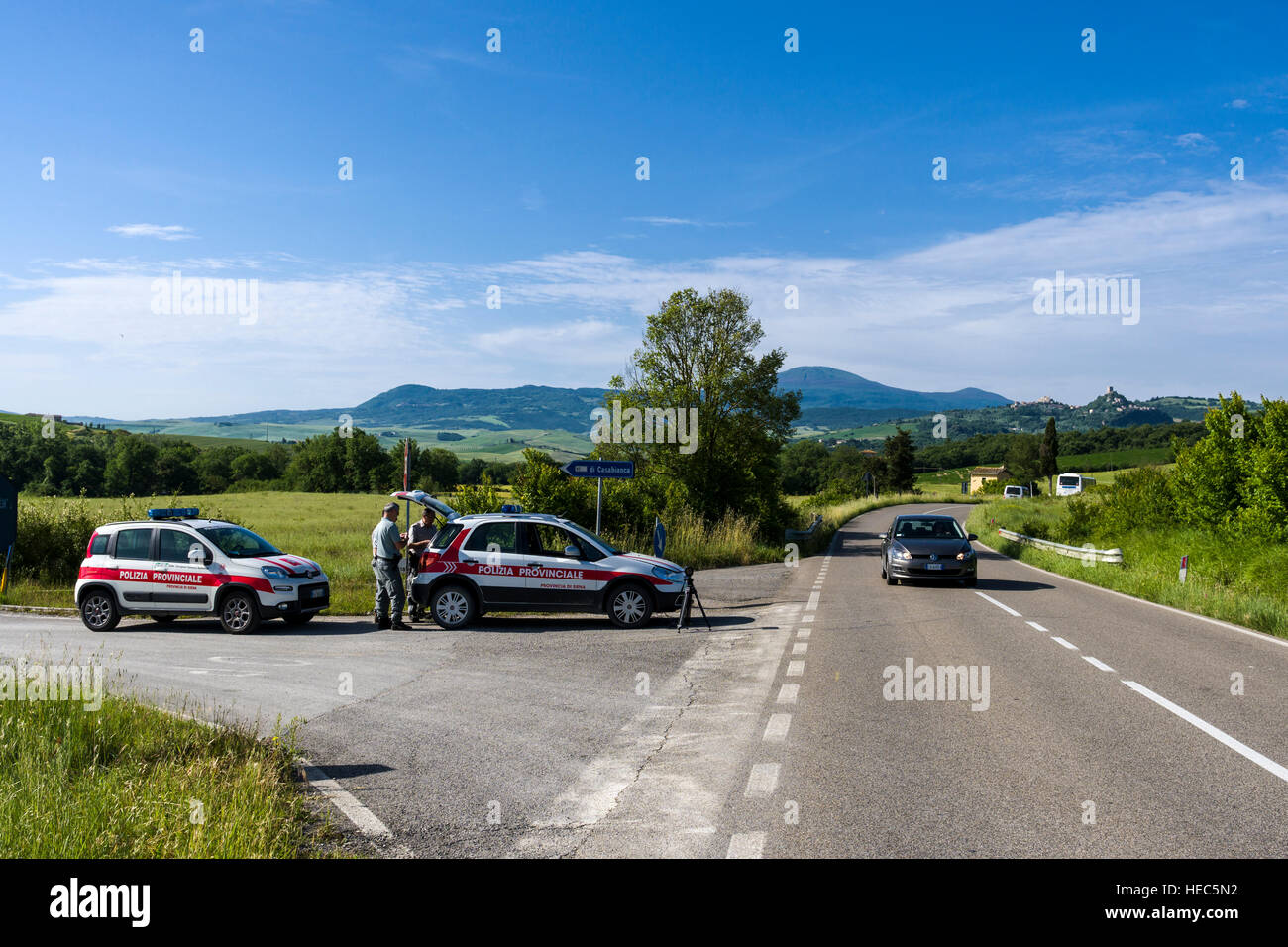 The police is setting up a radar control on a road in Val d’Orcia Stock Photo