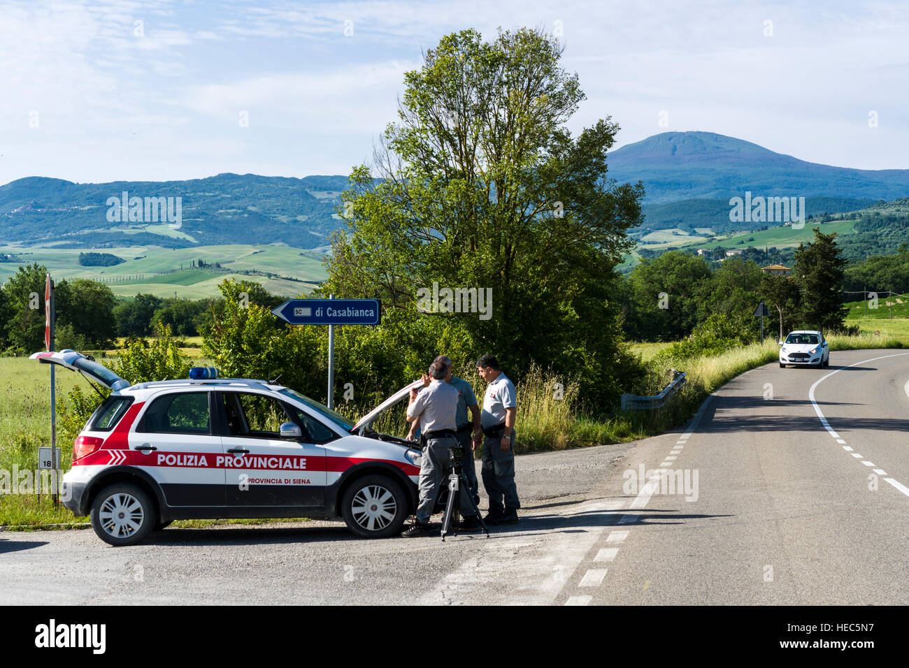 The police is setting up a radar control on a road in Val d’Orcia Stock Photo